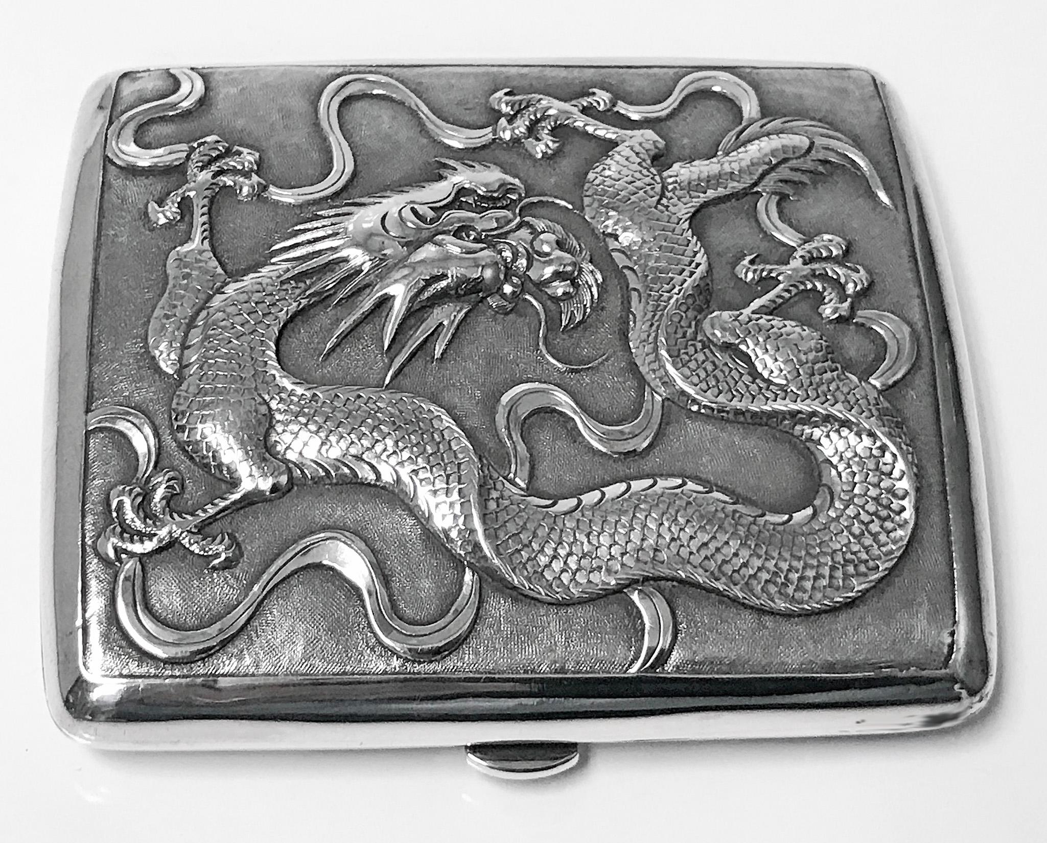 Antique Chinese export silver cigarette case, TC for Tuck Chang, circa 1900. The box of concave form one side with reliefs of dragons, the other side plain, gilded interior. Hallmarked 90, Chinese characters and TC. Measures: 3.25 x 3.0 x .50