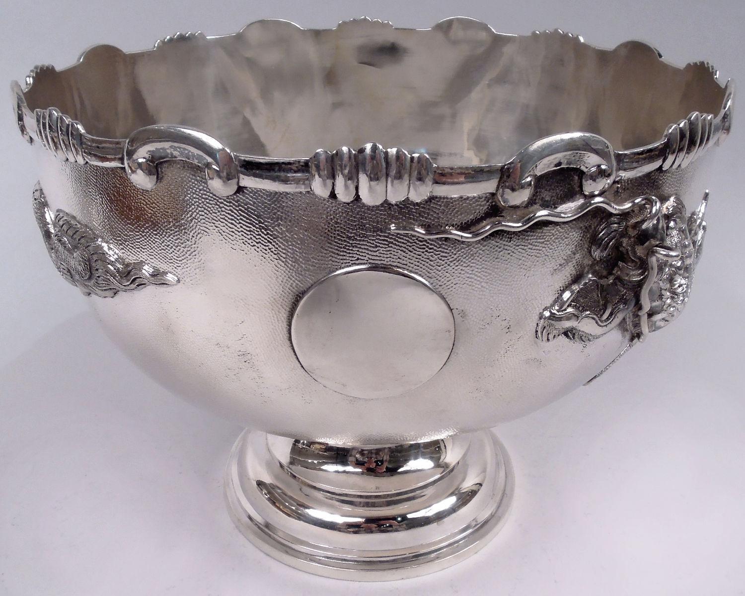 Chinese export silver centerpiece bowl on stand, ca 1910. Bowl round and curved on plain stepped foot; mouth rim has clusters of graduated gadroons and c-scrolls. Applied circle (vacant). Stand round with engraved central circle (vacant) in well and