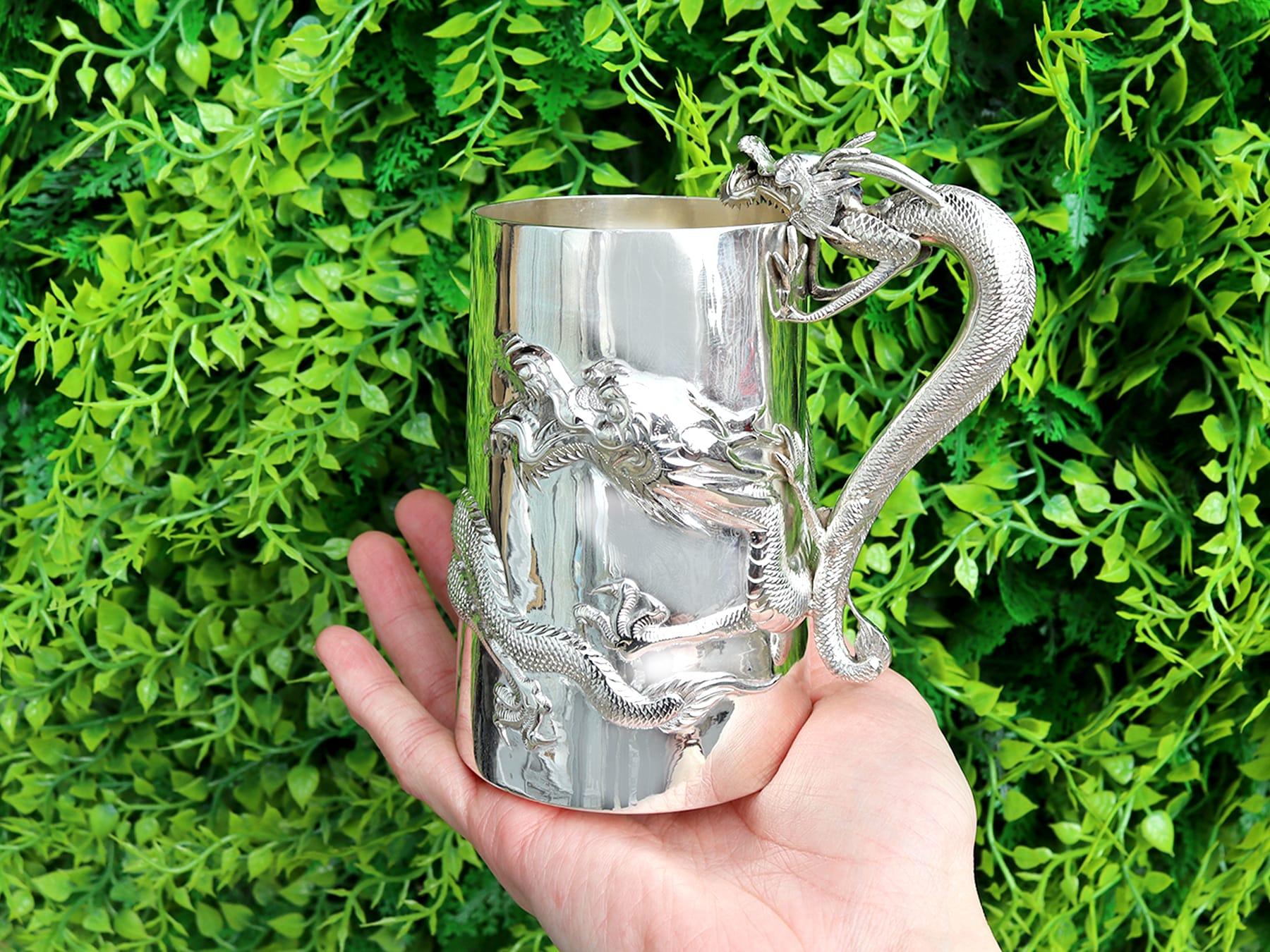 An exceptional, fine and impressive antique Chinese Export Silver mug with dragons; an addition to our oriental silverware collection.

This exceptional antique Chinese silver mug has a tapering cylindrical form.

The surface of the mug is