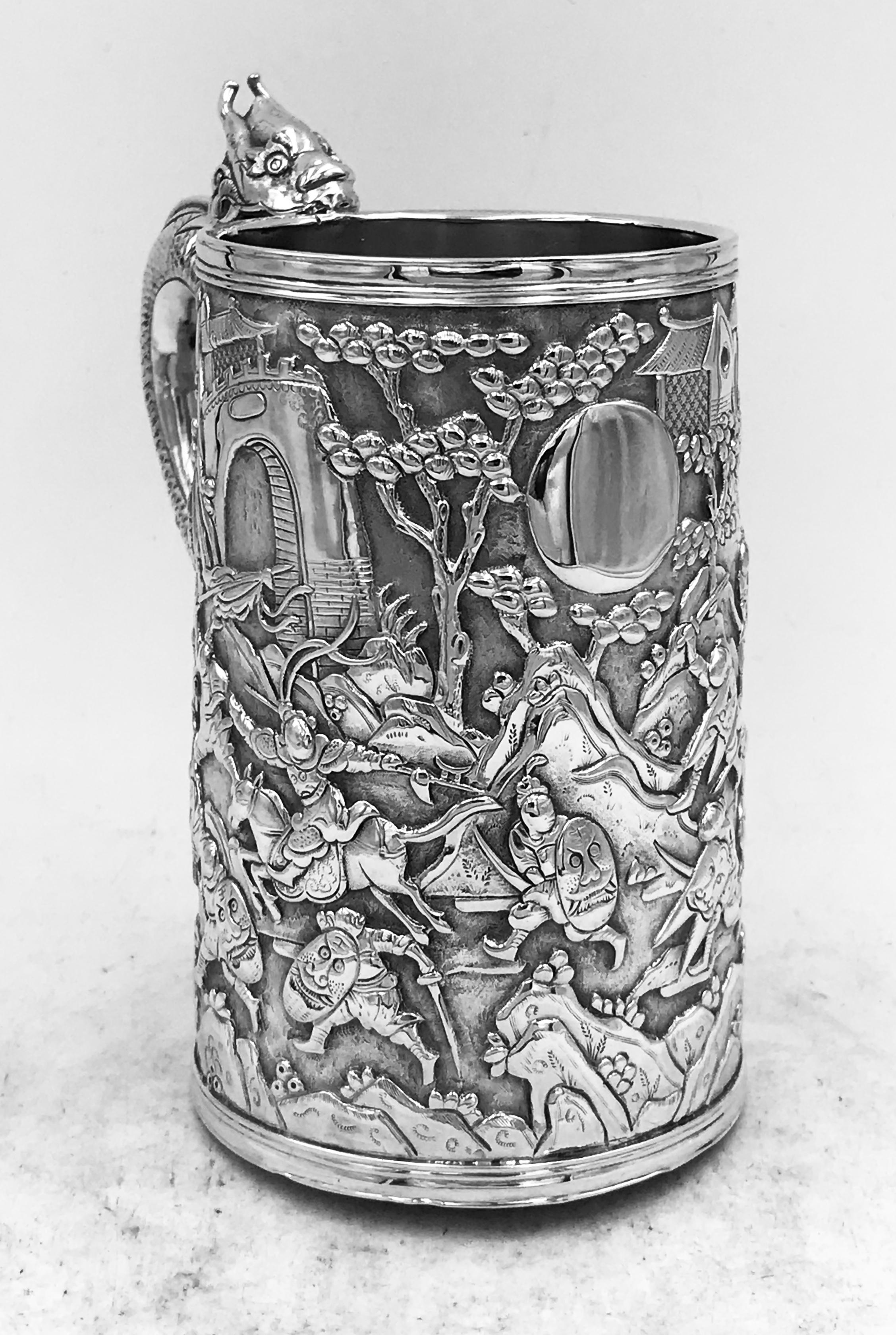 A Chinese silver mug of typical double-skinned construction, decorated with battle scenes against a matt background. It has a vacant cartouche and a dragon handle. Marked with HC, for Hung Chong 鸿昌.
Hung Chong was a retailer based in Canton from