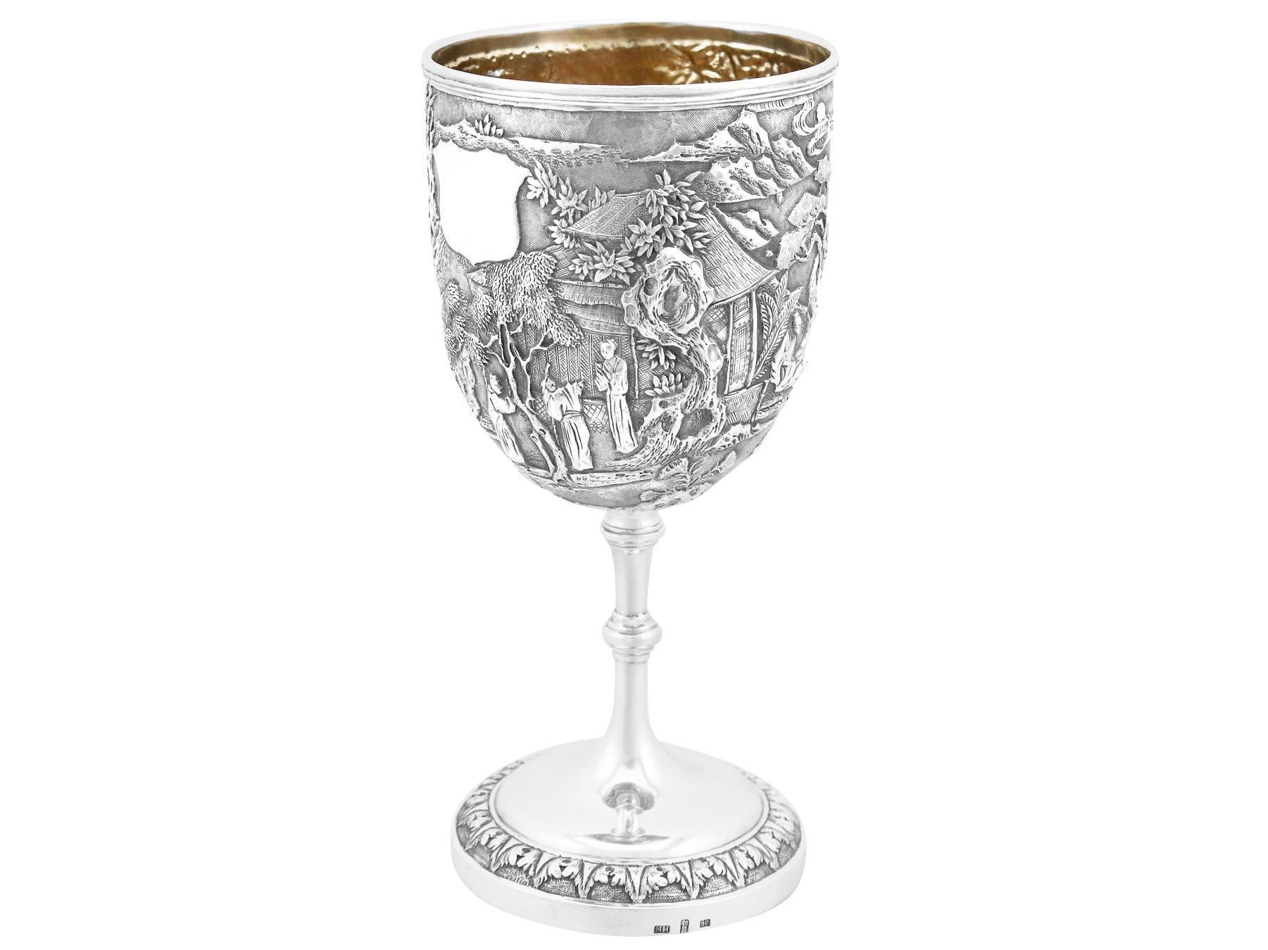 This exceptional antique Chinese Export silver (CES) presentation cup / goblet has a circular bell shaped form to a knopped stem and circular domed foot.

The large drinking vessel of this Wang Hing silver goblet is embellished with an exceptional