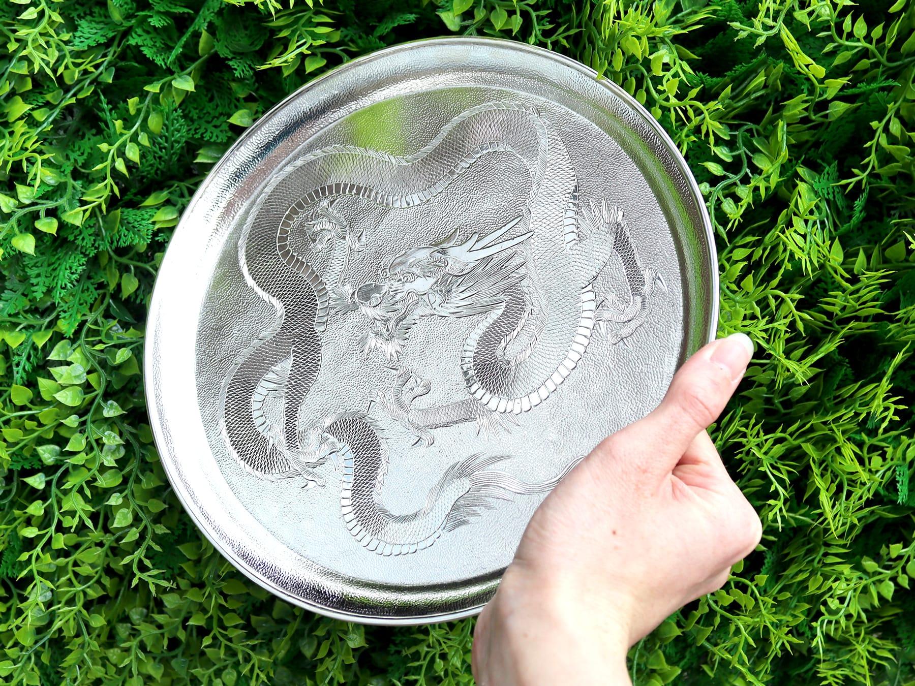 A fine and impressive antique Chinese Export silver salver; an addition to our ornamental serving trays collection.

This fine and impressive antique Chinese Export Silver (CES) salver has a circular rounded form.

The surface of this fine example