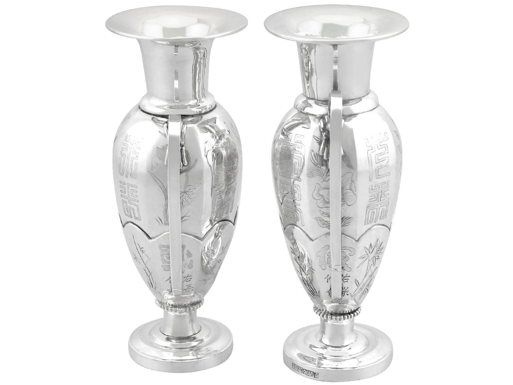 An exceptional, fine and impressive pair of antique Chinese export silver vases; an addition to our ornamental silverware collection.

These impressive antique Chinese Export silver vases have a circular panelled baluster form.

The surface of