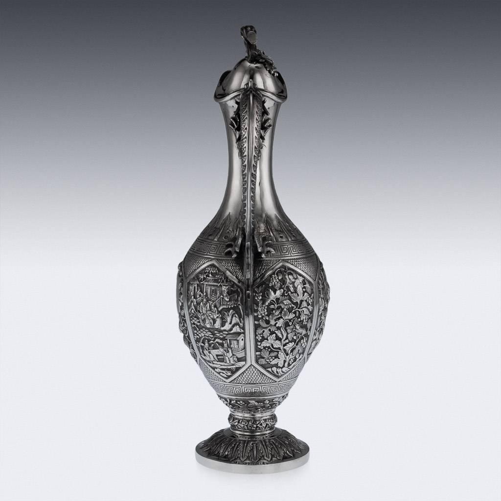 Antique 19th century Chinese Export solid silver wine ewer, impressive and exceptionally fine, of baluster form, the body showing a compendium of the finest techniques and styles used in Chinese Export Silver: the domed circular base chased with