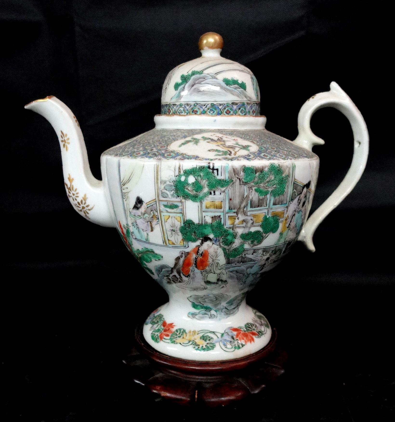 Famille Rose Export Porcelain teapot depicting figures, flowers, and birds, depicting the living style in a traditional Chinese garden villa in the early 19th century, hardwood stand included. Ric061.

  
