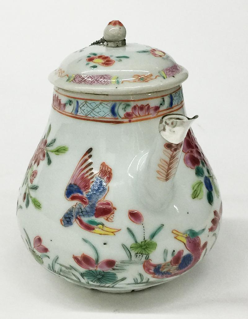 18th Century Chinese porcelain Famille Rose Teapot with Cover

An early Qianlong enameled porcelain teapot with a scene of birds and Peonies in a garden , 1736-1795.
With a silver mounted sprout and chain connected with the lid of the teapot
The lid