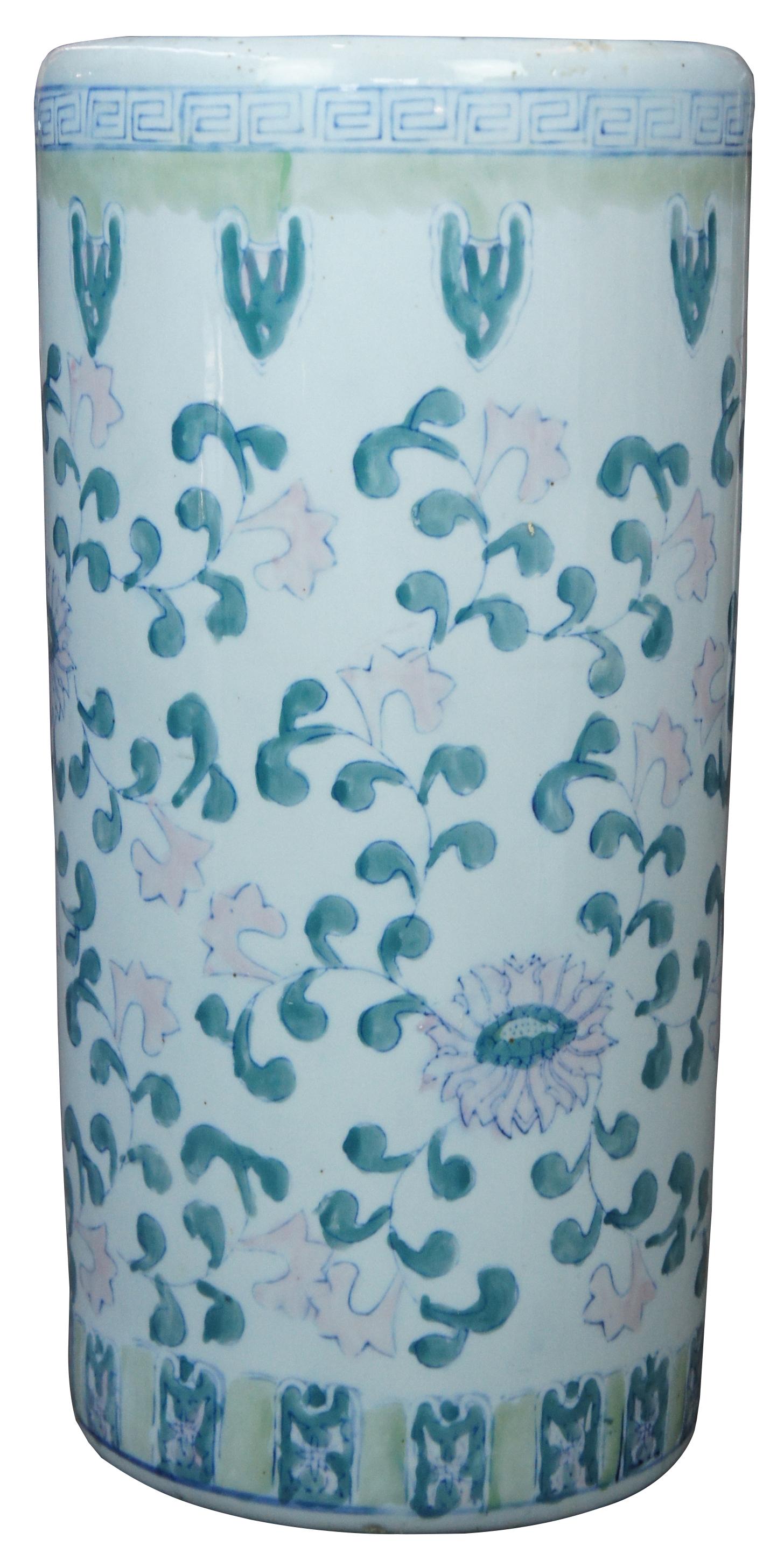 Antique Chinese umbrella stand or cane holder. Made of porcelain featuring hand painted floral and foliate designs in pink, blue, and green, patterned between abstract banding with a Greek key border.  Measures: 18