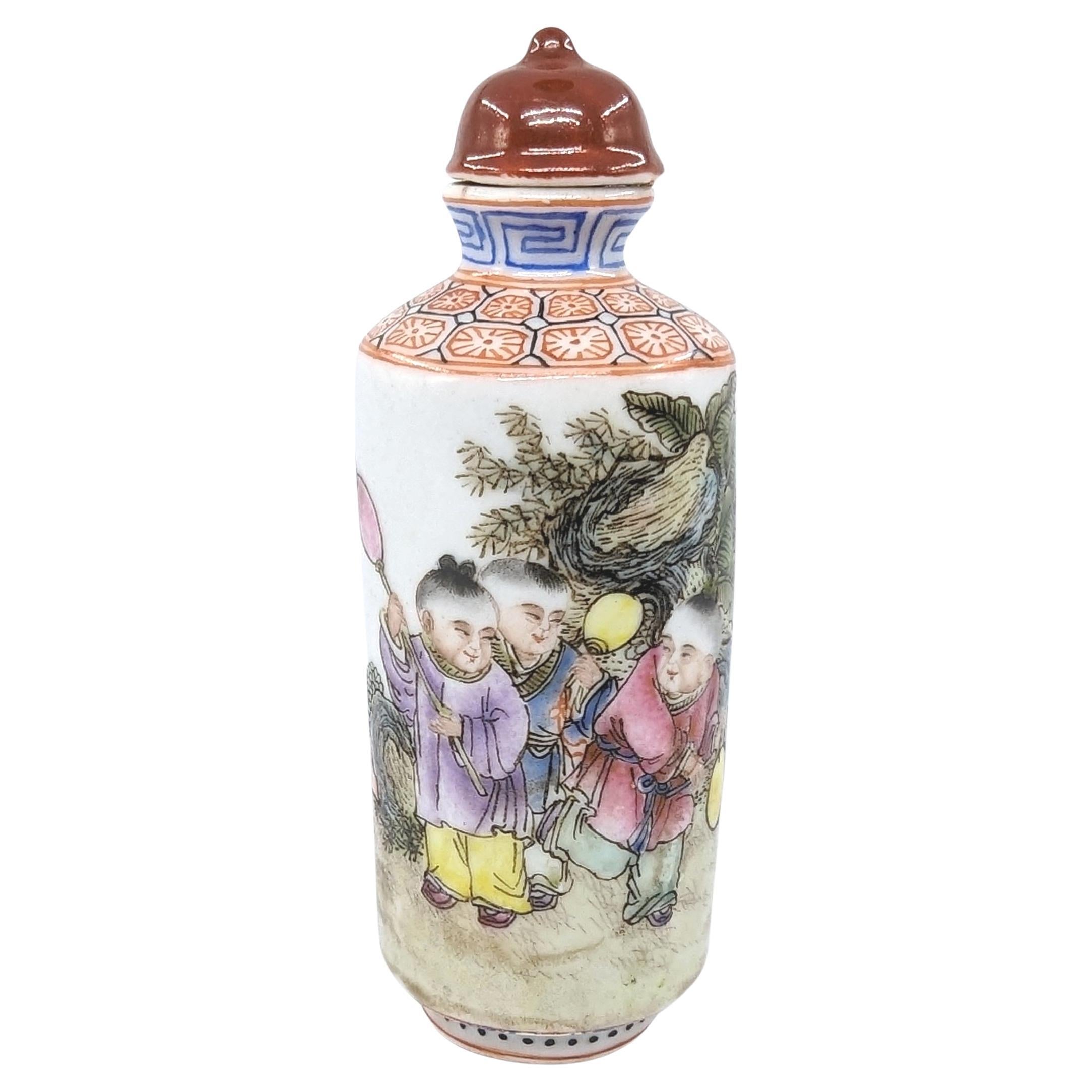 Antique Chinese poly-chrome fencai  porcelain snuff bottle in cylindrical form, finely decorated with 3 boys in a garden scene with poetic versus in calligraphy, with seeded cell patterns to shoulder, and red four character  Guangxu mark to base