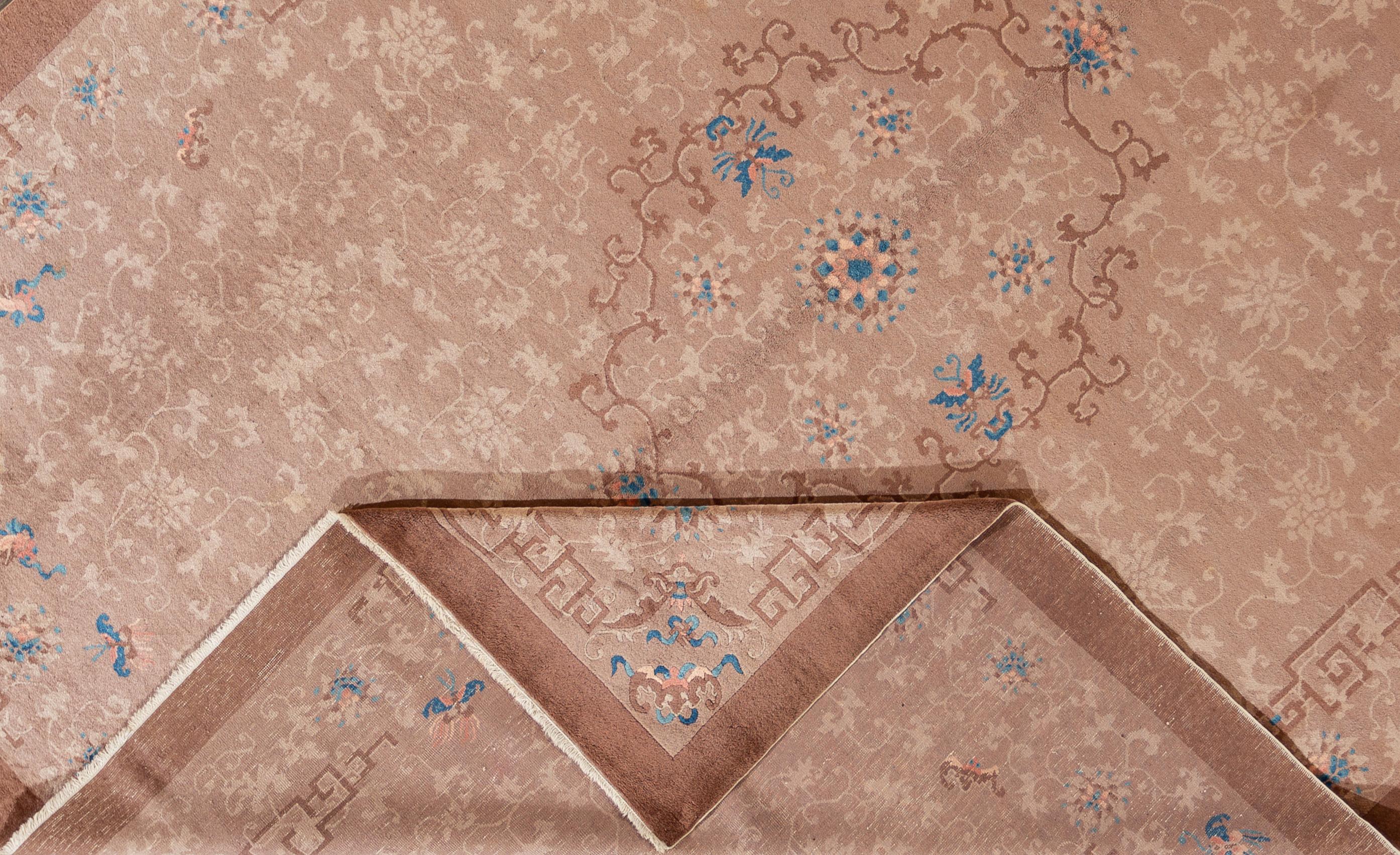 A 1910s antique hand knotted Chinese Feti rug with a beige field and an all-over design. This rug measures: 9'2
