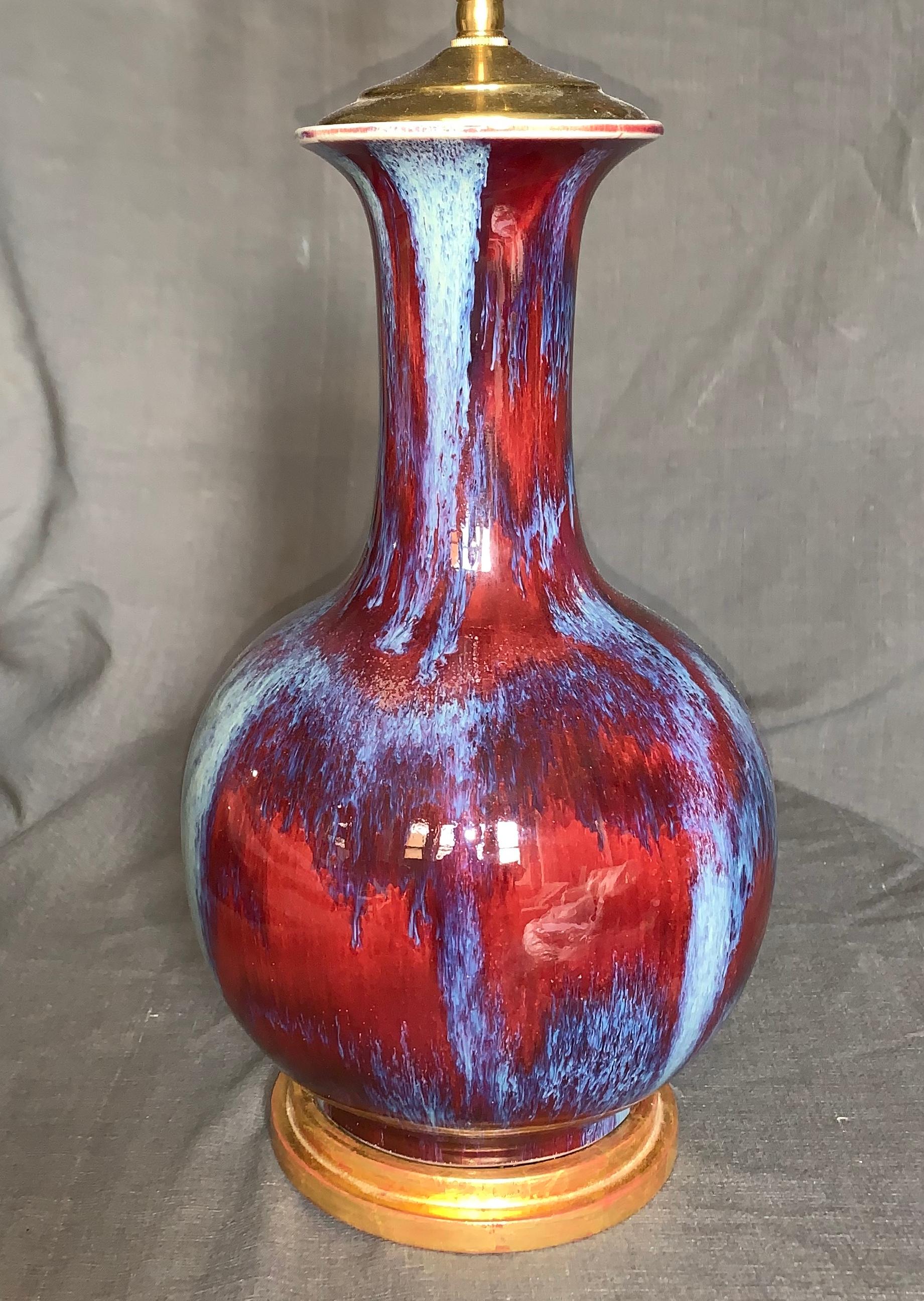 Antique Chinese flambé lamp. Chinese flambé vase in rich mottled red and blue glaze in original condition with gilt water base, not drilled but newly electrified with silk cord and switch. China, mid-19th century. Blue silk lampshade