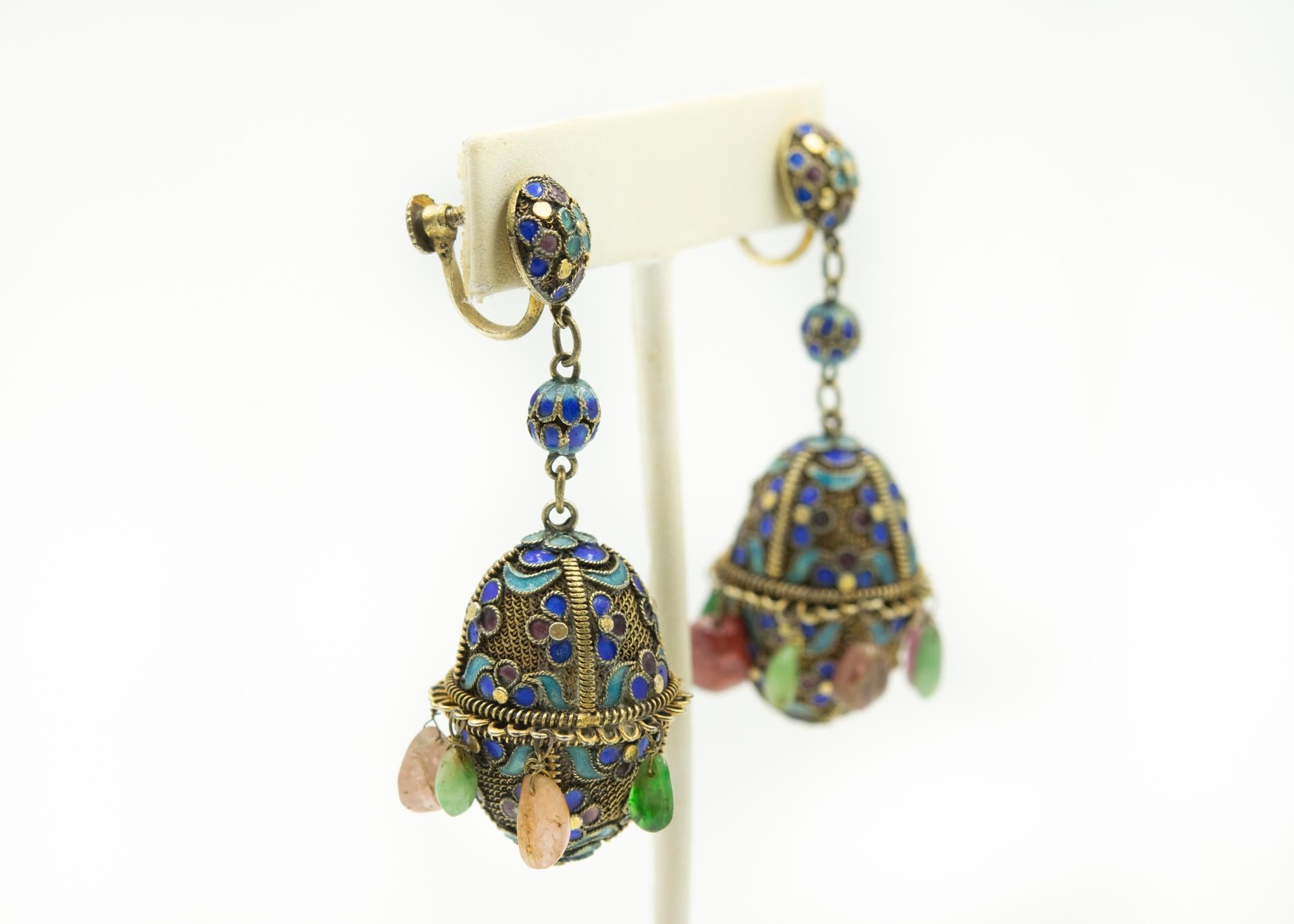 Stunning early 20th century Chinese gilt sterling silver earrings are in the form of eggs. They feature dangling drops which sway with every movement. On the top, there is a button shaped floral enamel stud with  a screw clip-on back.  From the stud