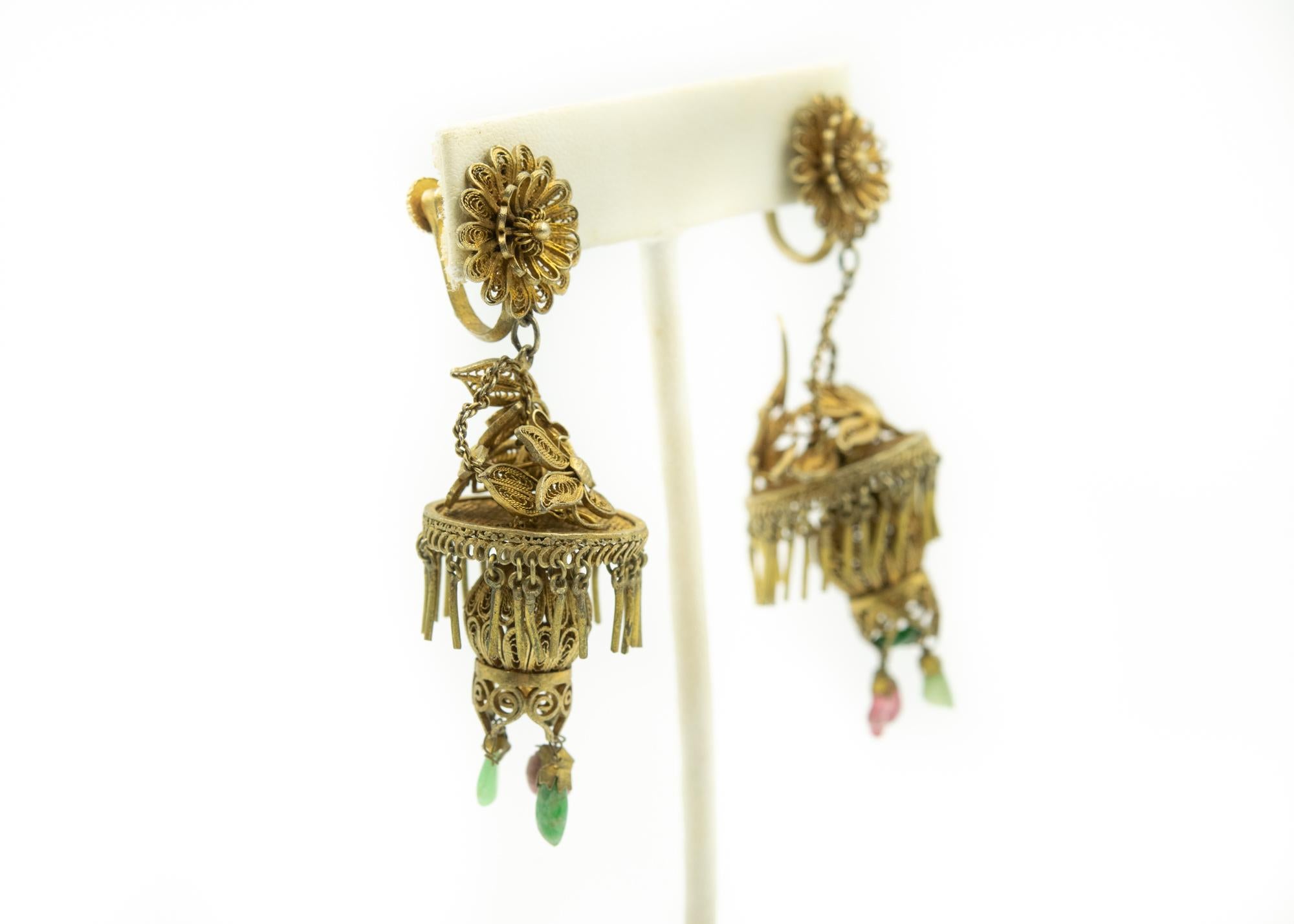 These early 20th century gilt sterling silver earrings are in the form of Chinese lanterns.  They feature 2 levels of dangling drops which sway with every movement.  The top layer are fringe and the bottom has pink tourmalines and green jades drops.
