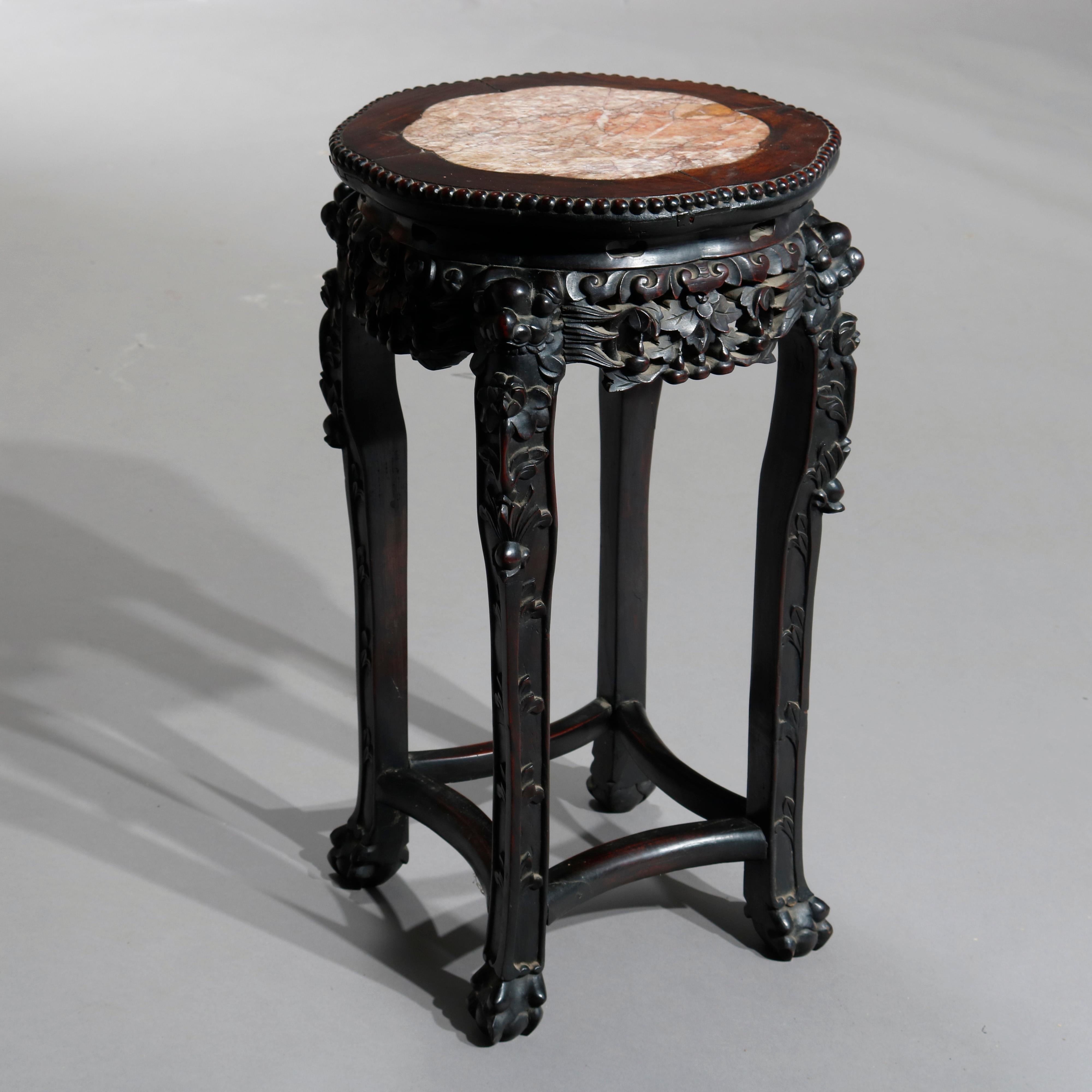 An antique Chinese plant stand offers octagonal inset marble top with beaded trimming surmounting rosewood base having deeply carved foliate skirt and raised on cabriole legs terminating in paw feet, c1920

Measures- 24.25