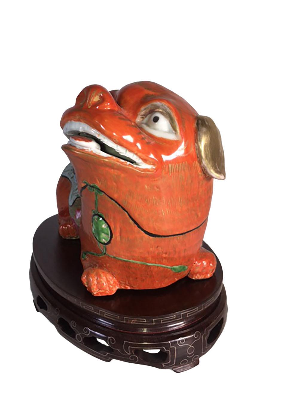 An antique Chinese Foo Dog with silver inlaid wood stand. Circa 1900 very fine detail.
