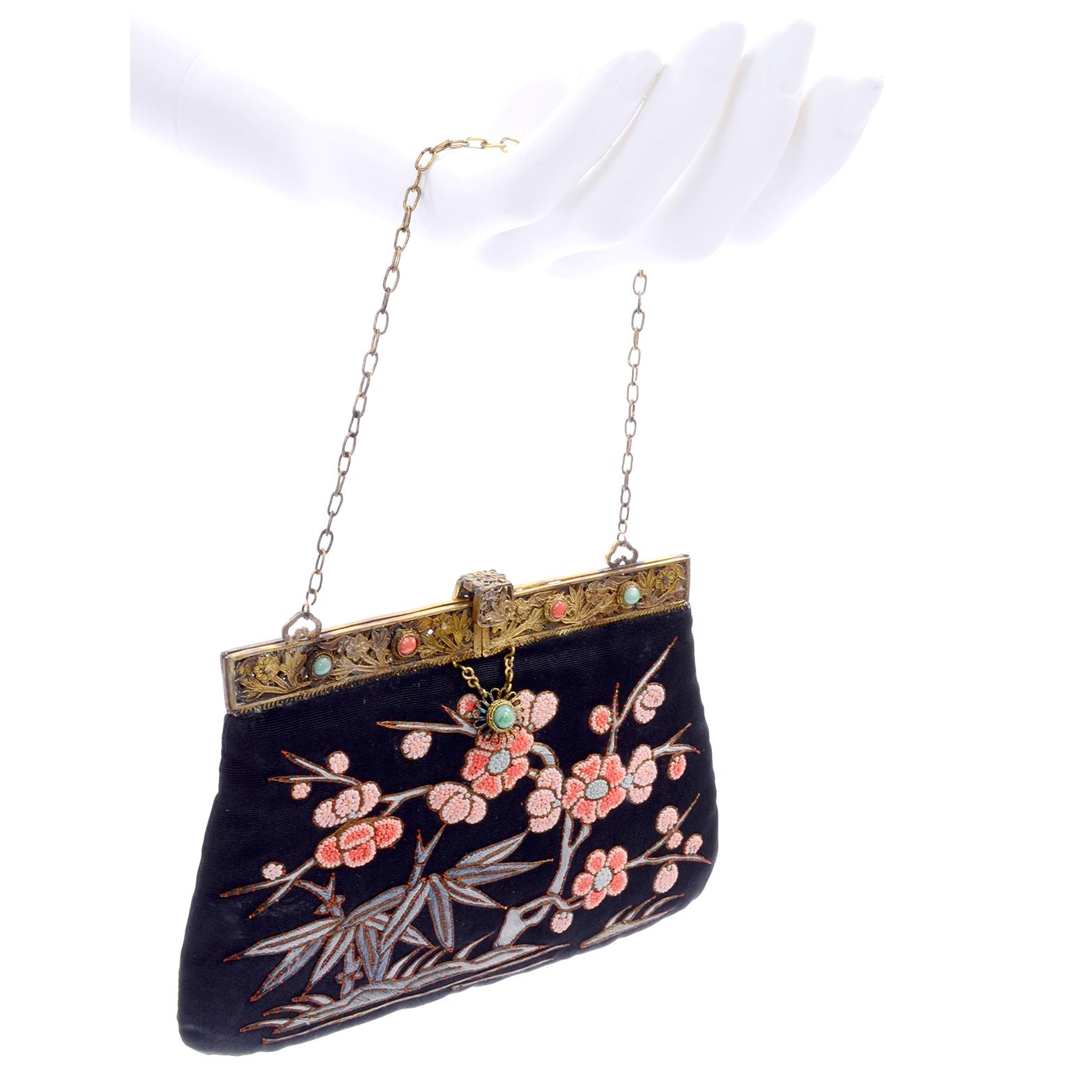 This is such an incredible antique handbag in black with embroidered leaves and flowers. The flowers are done with the 