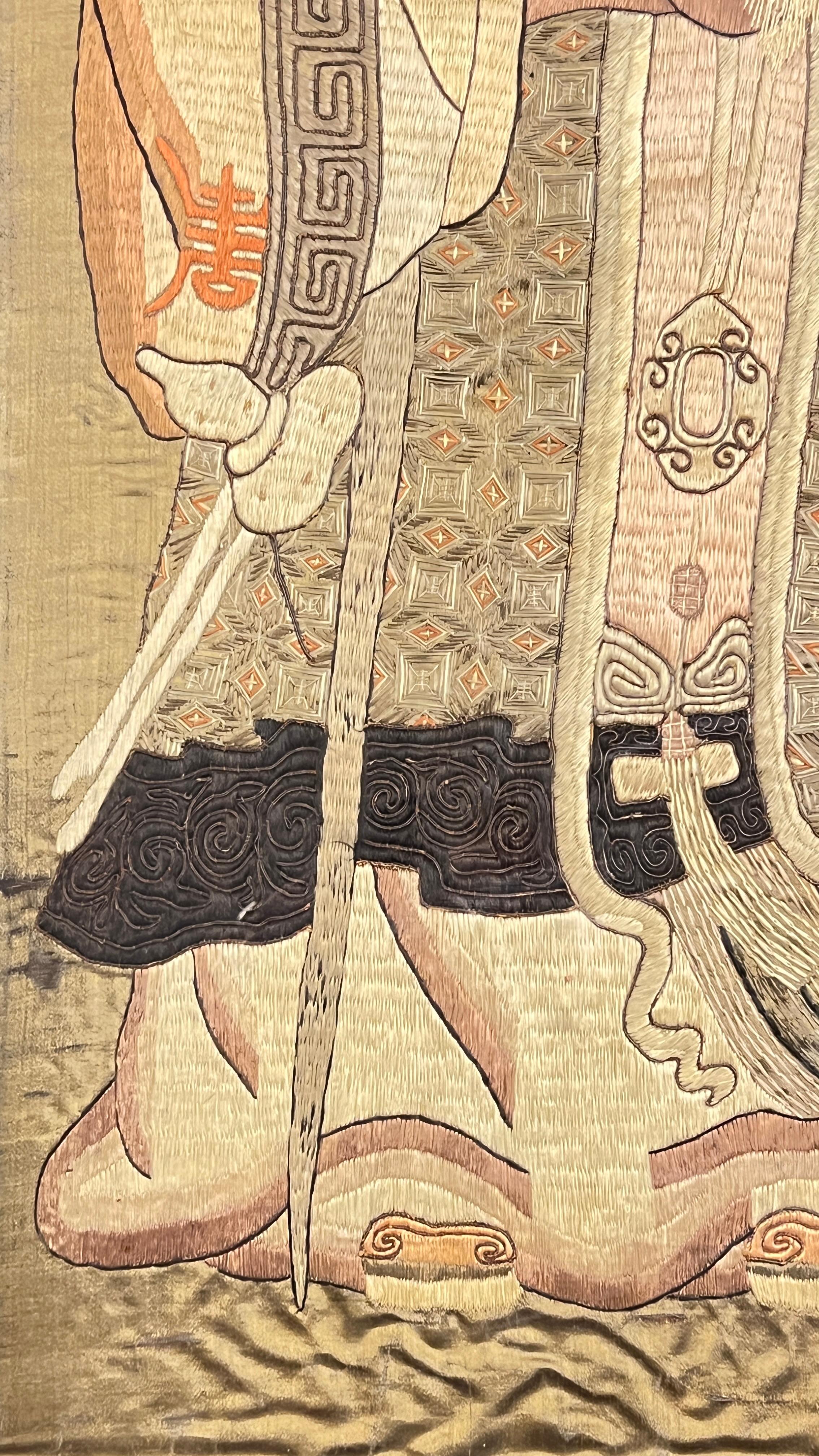Exceptional antique (19th century) embroidery needlework on silk depicting Shou Lao, god of longevity, with his familiar attendant and deer by his sides, mounted in a unique period mirrored and glazed glass frame measuring 33 1/2 by 55 3/4 by 1 inch.