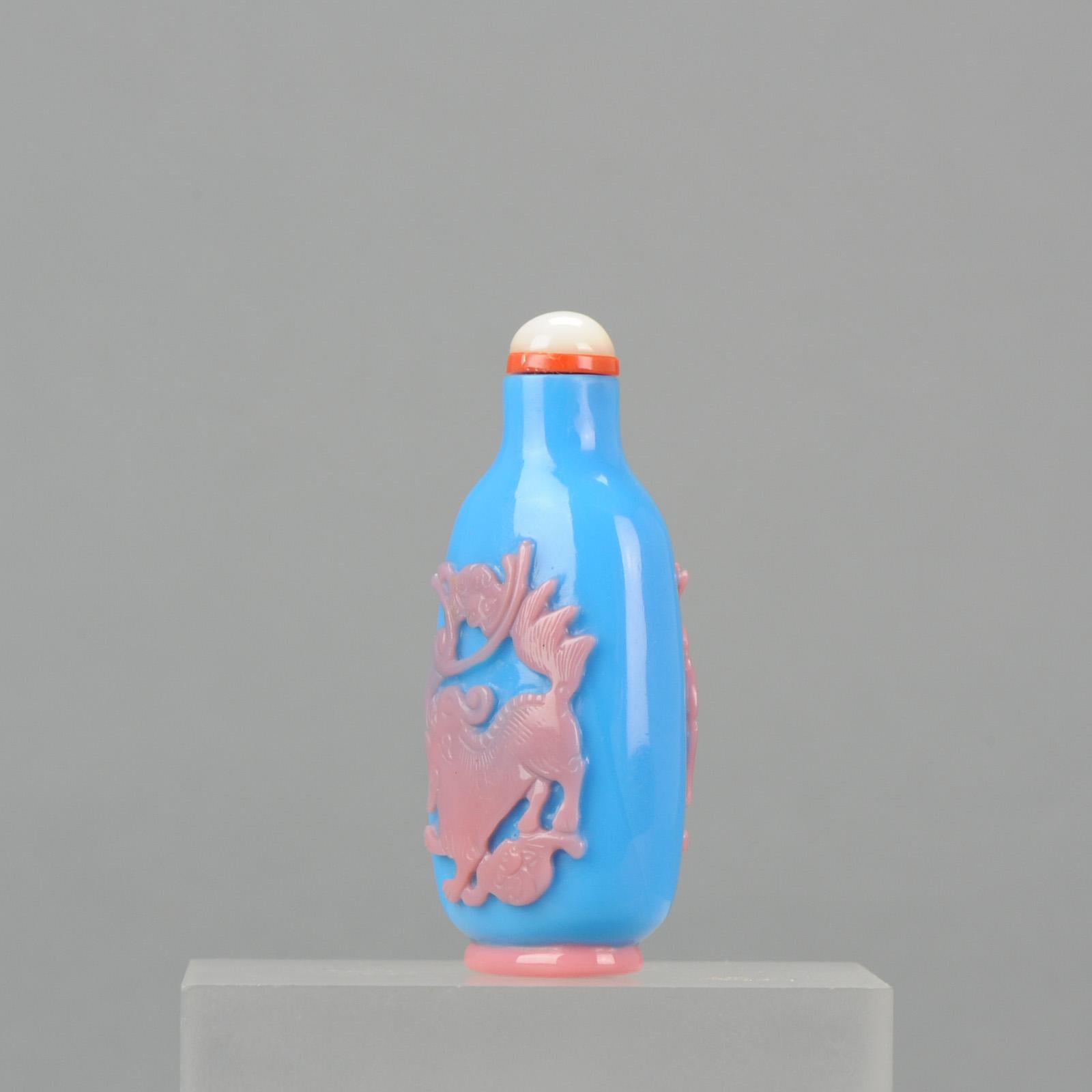 An cheerful snuff bottle with colorful decoration of foo lion

Provenance: Collection Morpurgo Amsterdam

Condition
Overall condition near perfect, a small imperfection to the pink. Size: Without stopper 63mm. With stopper 70mm

Period
Qing
