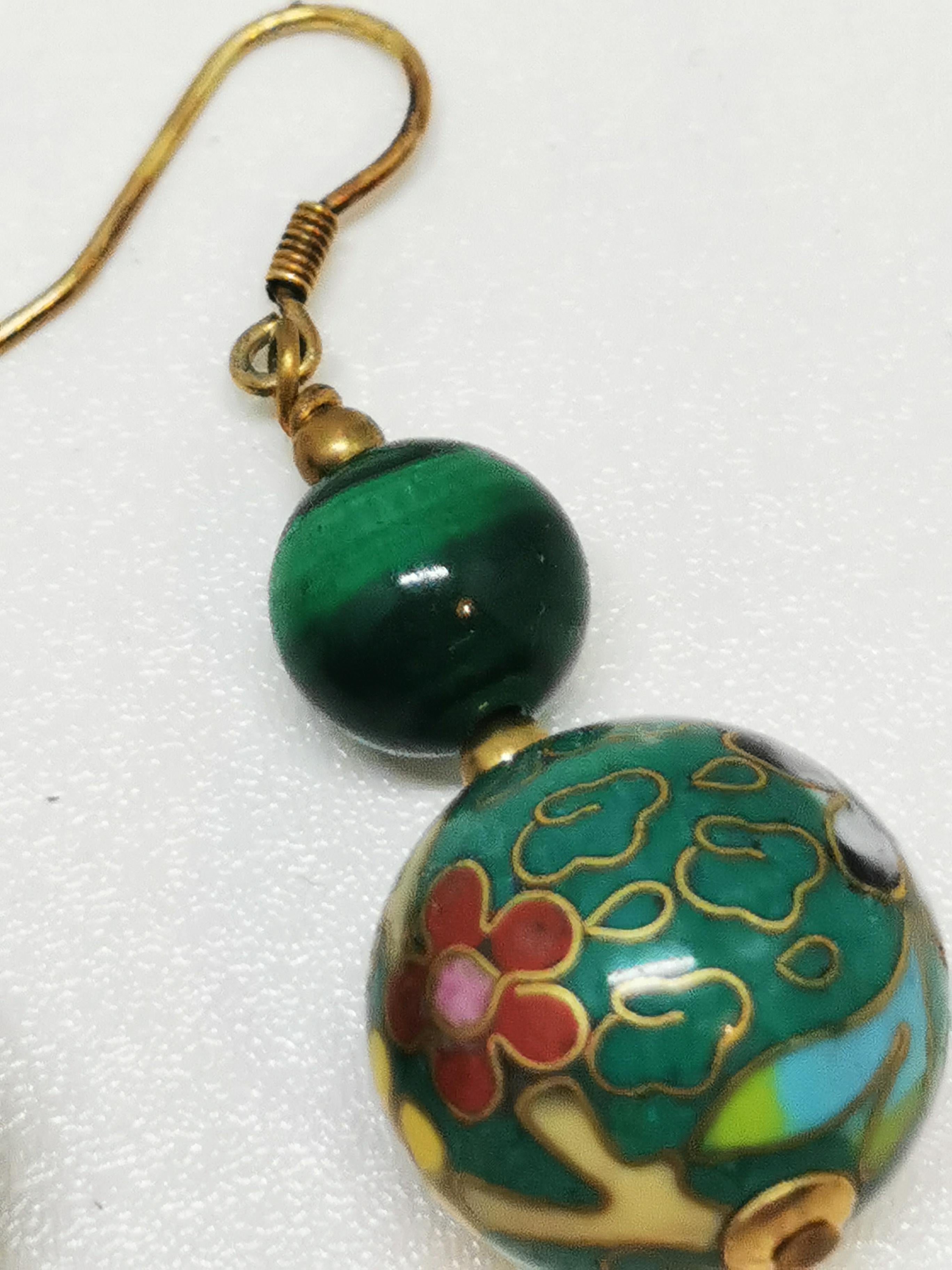 Antique Chinese Green Cloisonné Drop Bead Earrings with Floral Details

Elevate your accessory game with these exquisite antique Chinese green cloisonné drop beads earrings, featuring intricate floral designs. Crafted in the post-World War II era,