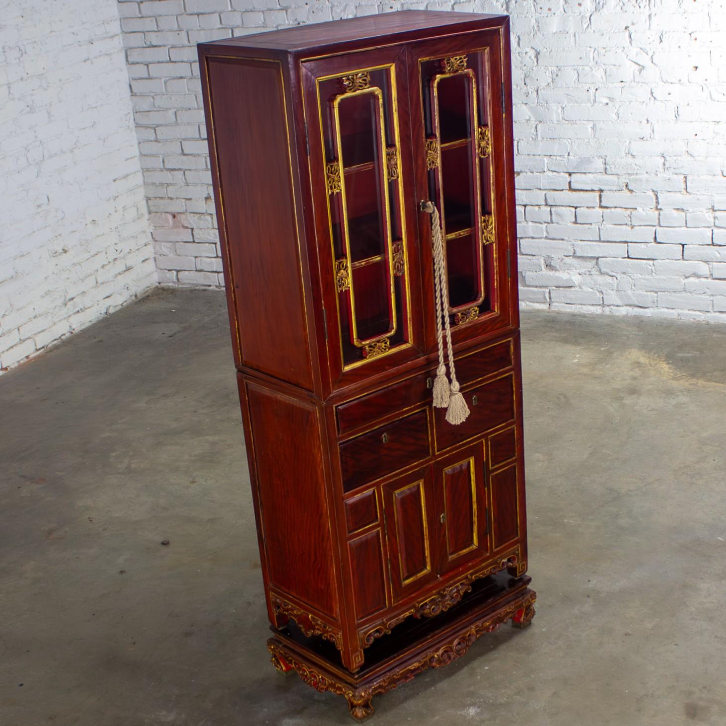 Handsome antique Chinese 3-part stacking display or China cabinet composed of hand carved & gilded Chinese Elm. 3 parts include: 1 top unit with glass doors, gilded details & brass hardware, a working brass key for all keyholes, & 2 fixed inner wood