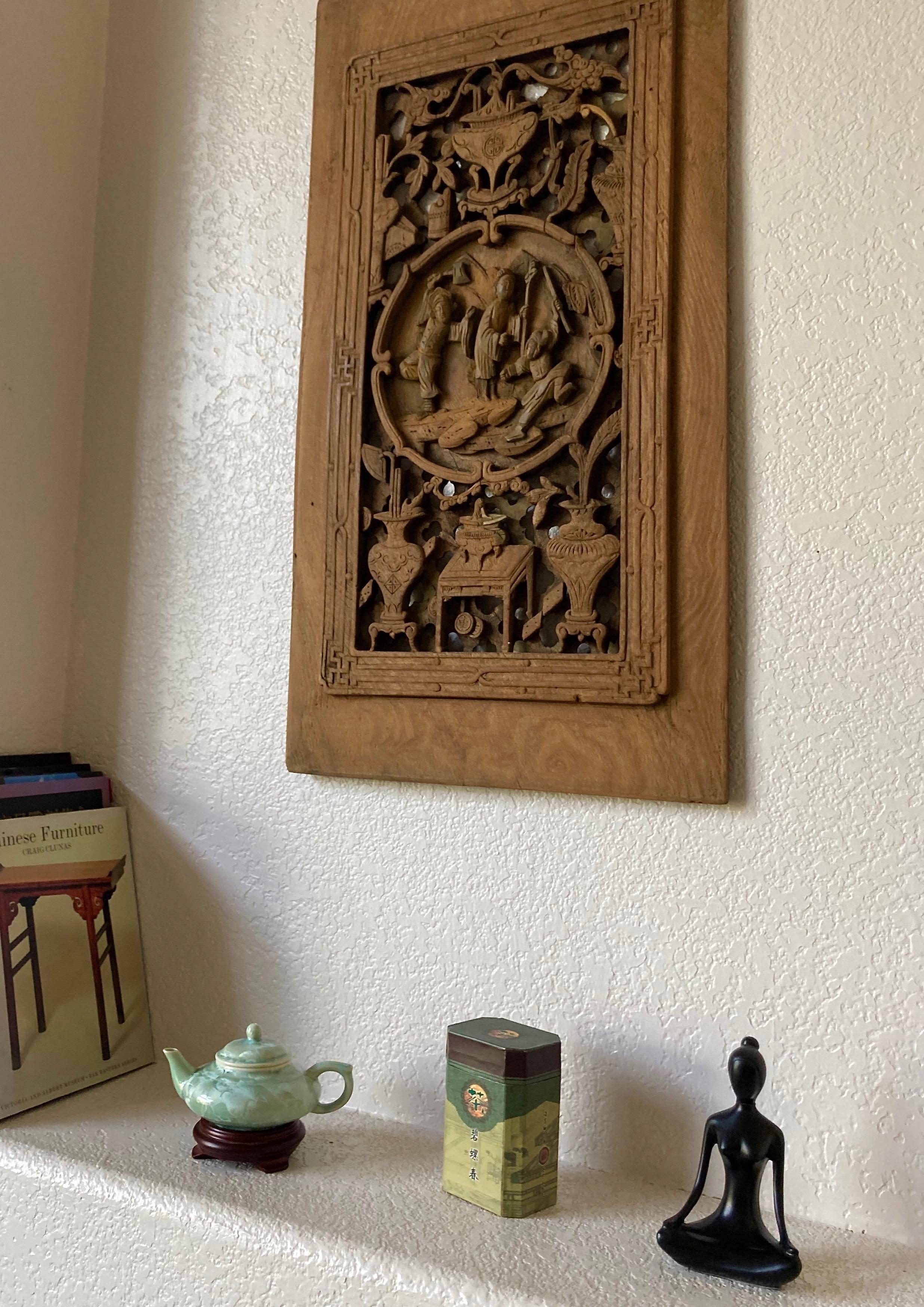 This exquisite unframed panel has a circular center carving with personage, dragon and floral motifs. It includes three men holding armaments. Has an unusual 3D carving effect. Hand carved from a solid piece of wood.
