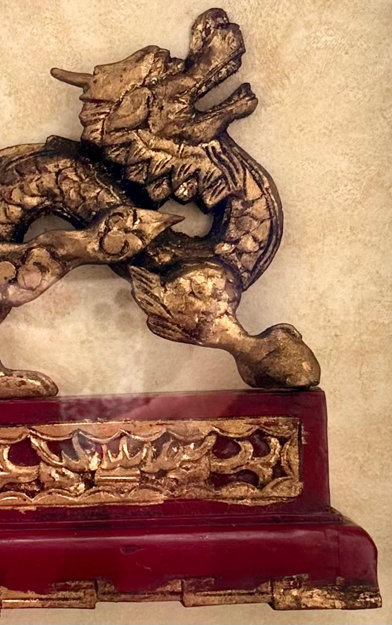 Antique Chinese Hand Carved Wood Gilt Dragon in Shadow Box.

Chinese shadow box features a hand carved wood and gilded Dragon from the Qing Dynasty. It is mounted in a massive and deep contemporary shadow box matted under glass. The large