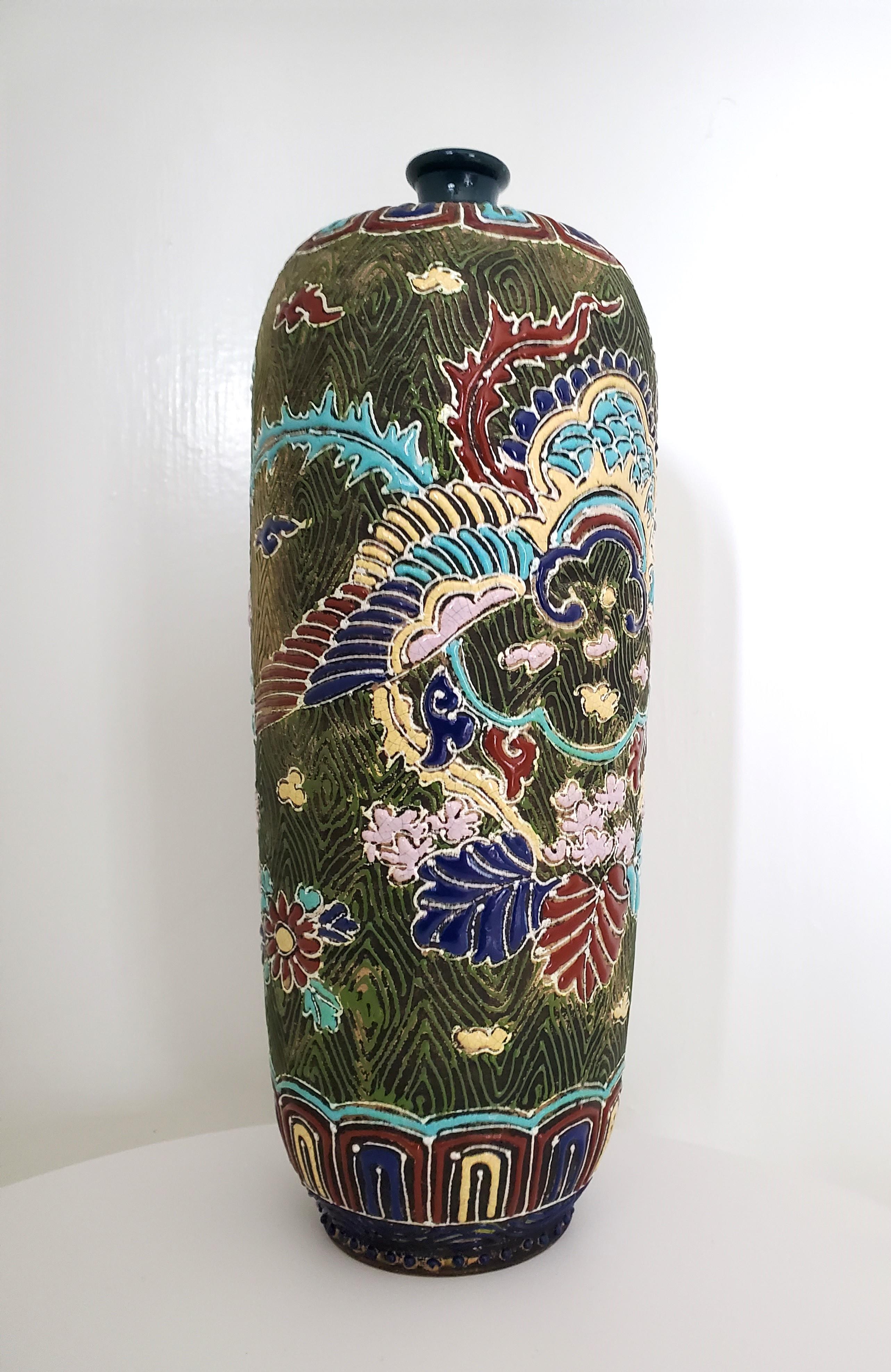 This unique hand-enamelled earthenware sleeve vase is decorated in enamel relief of an archaistic style with clouds, flowers, leaves, and an abstract rendering of a phoenix. The main body is dark green with a dark olive-green slip enamel pattern.