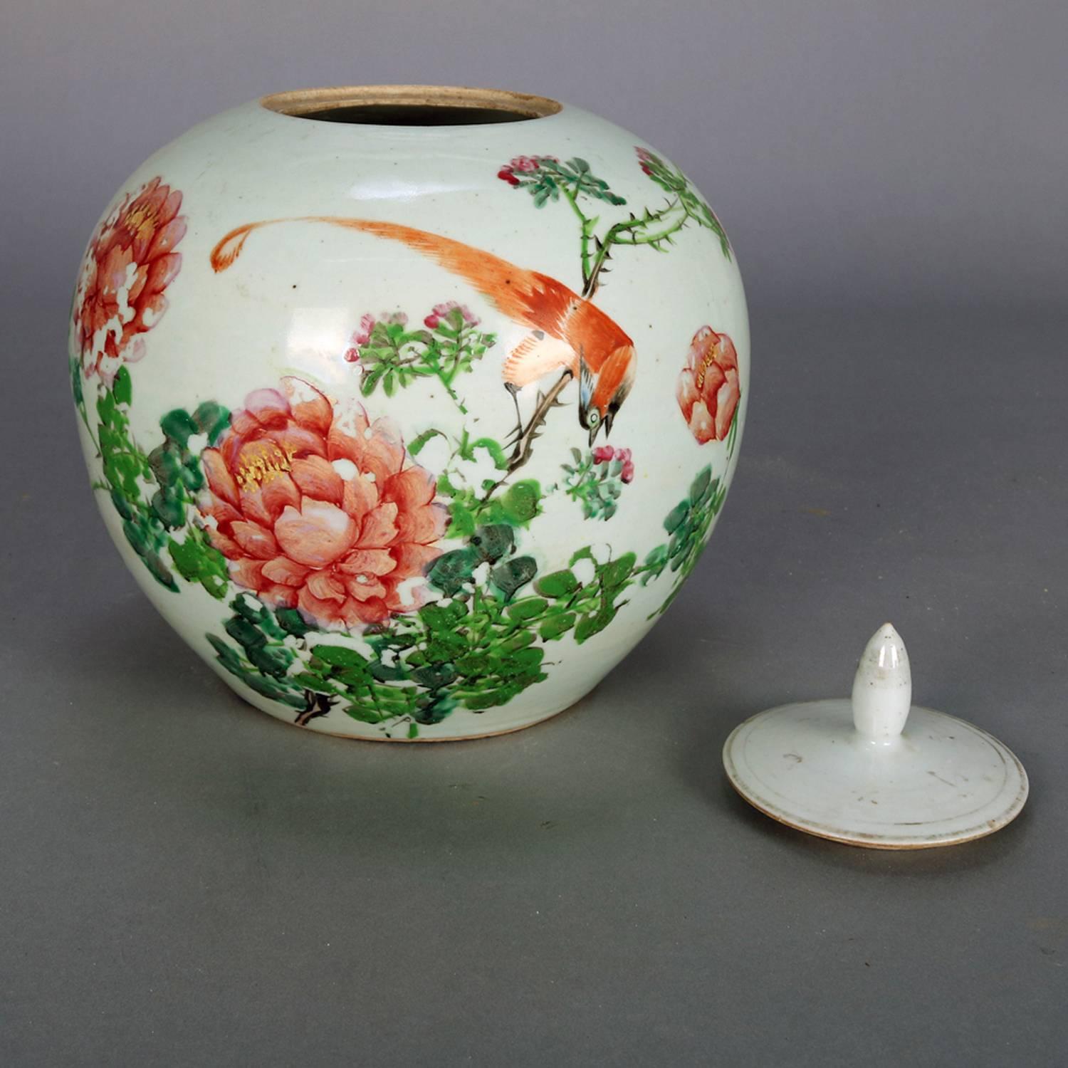 Antique Chinese hand-painted porcelain lidded ginger jar features floral garden scene with bird of paradise, gilt highlights, en verso chop marks, 19th century.

Measures: 10