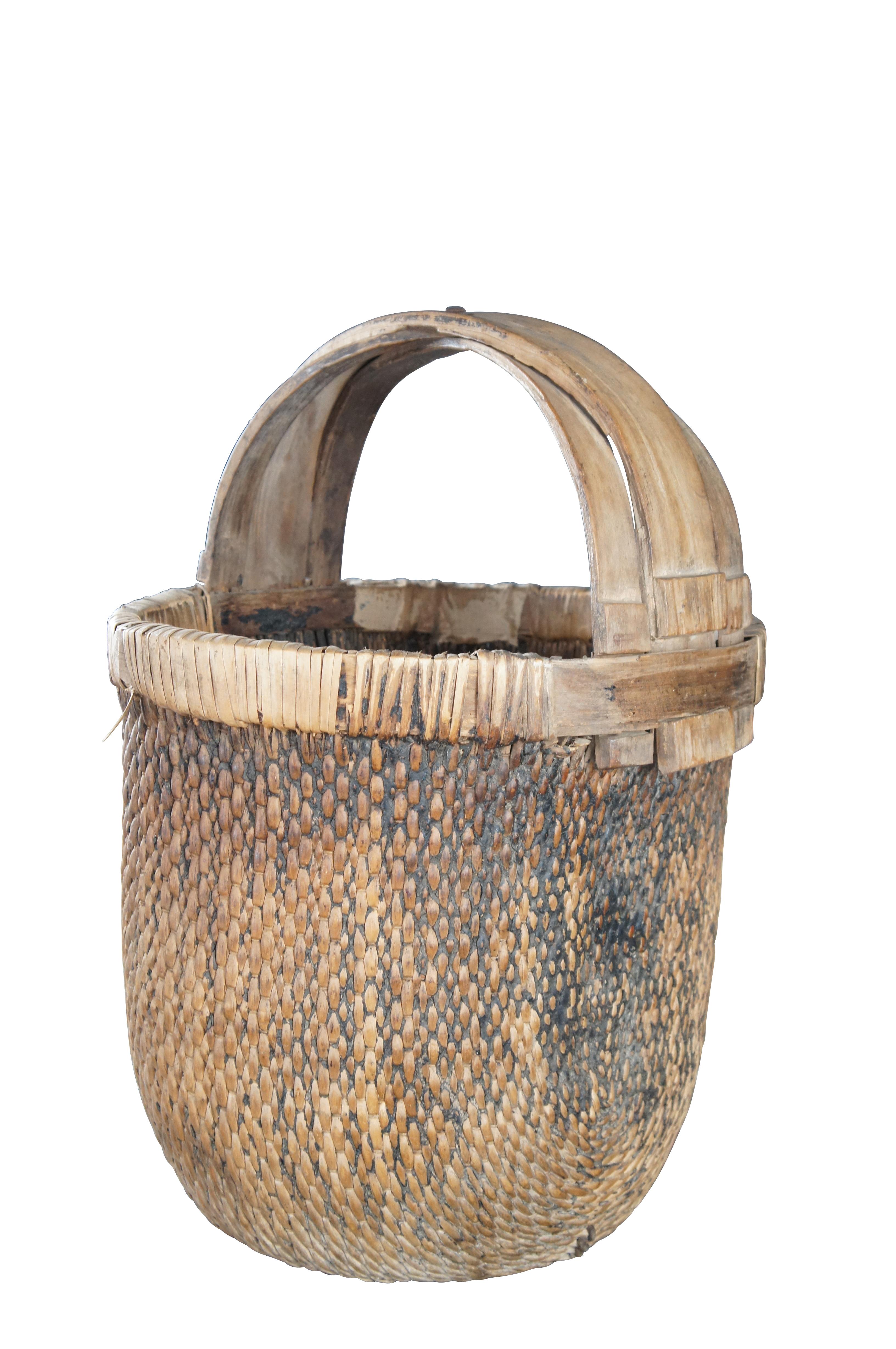 Early 20th Century Chinese Rice Basket. Made from woven reed with a bentwood handle and calligraphy.

Dimensions:
16