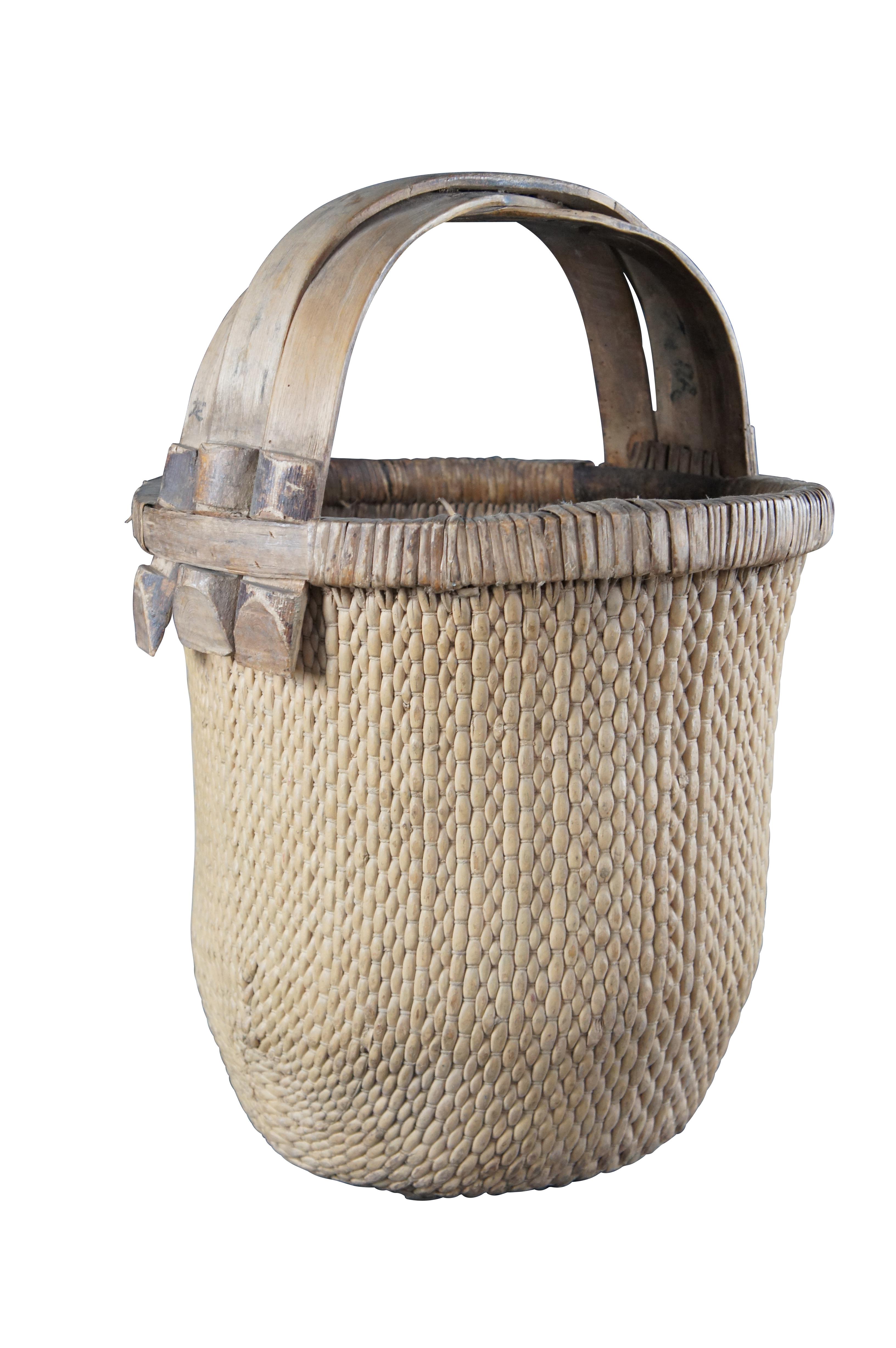 Early 20th Century Chinese Rice Basket. Made from woven reed with a bentwood handle and calligraphy.

Dimensions:
17