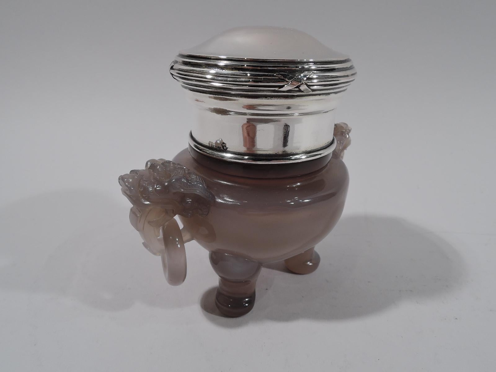 Turn of the century Chinese hard stone koro. Bellied bowl on sturdy leg-and-paw supports. Carved foo dog side mounts with loose-mounted rings. Short neck collar and raised and reeded cover are 800 silver. Cover has German marks.