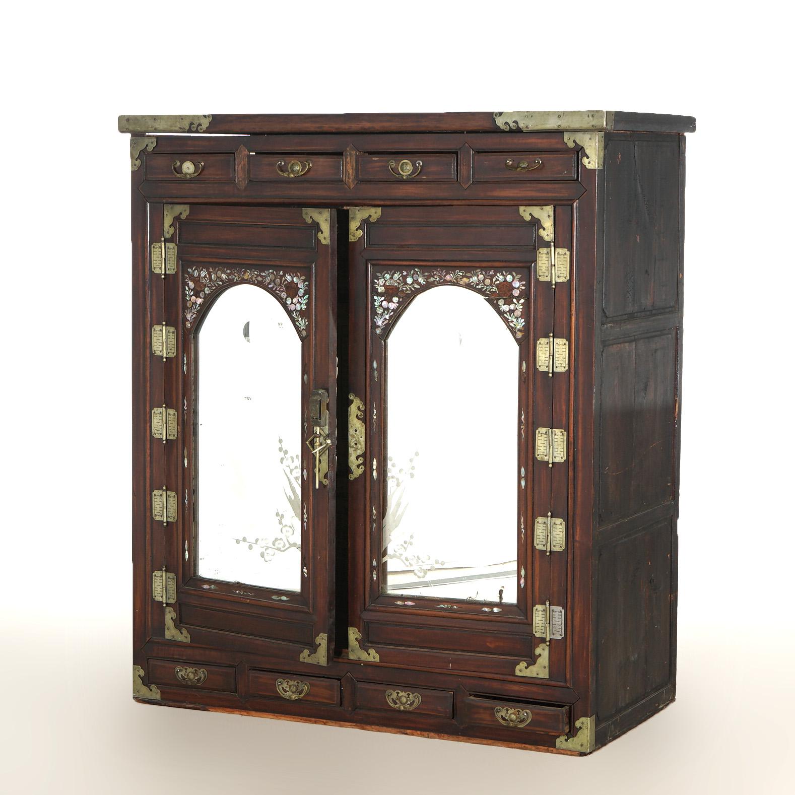 ***Ask About Reduced In-House Shipping Rates - Reliable Service & Fully Insured***

An antique Chinese wedding cabinet offers hardwood construction with double doors having arched mirrors, inlaid mother of pearl decoration, and strap hinges opening