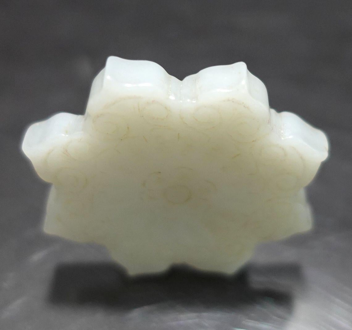 A nice hand-carved antique, Chinese Hetain Carved White Jade Pendant in eight angles of lotus leaves. The pendant has two different carved patterns on two surfaces very delicate and unique result, from the 19th Century.
The color is presented in