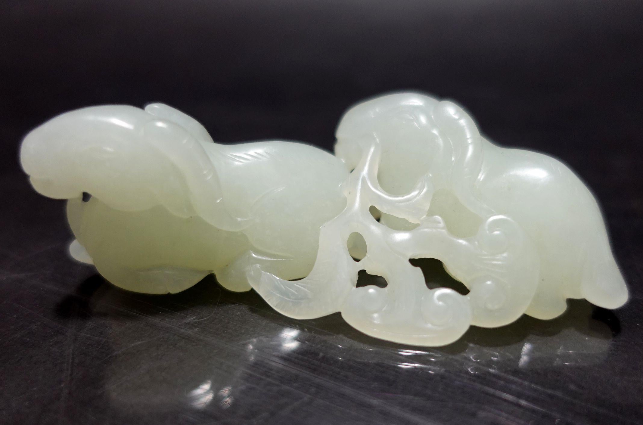A nice hand-carved antique, Chinese Hetain White with a light celadon Jade of Two Rams from the 19th Century.
The color is presented in white with a very light celadon and the context of the body is very clean inside of the entire body.
The 
