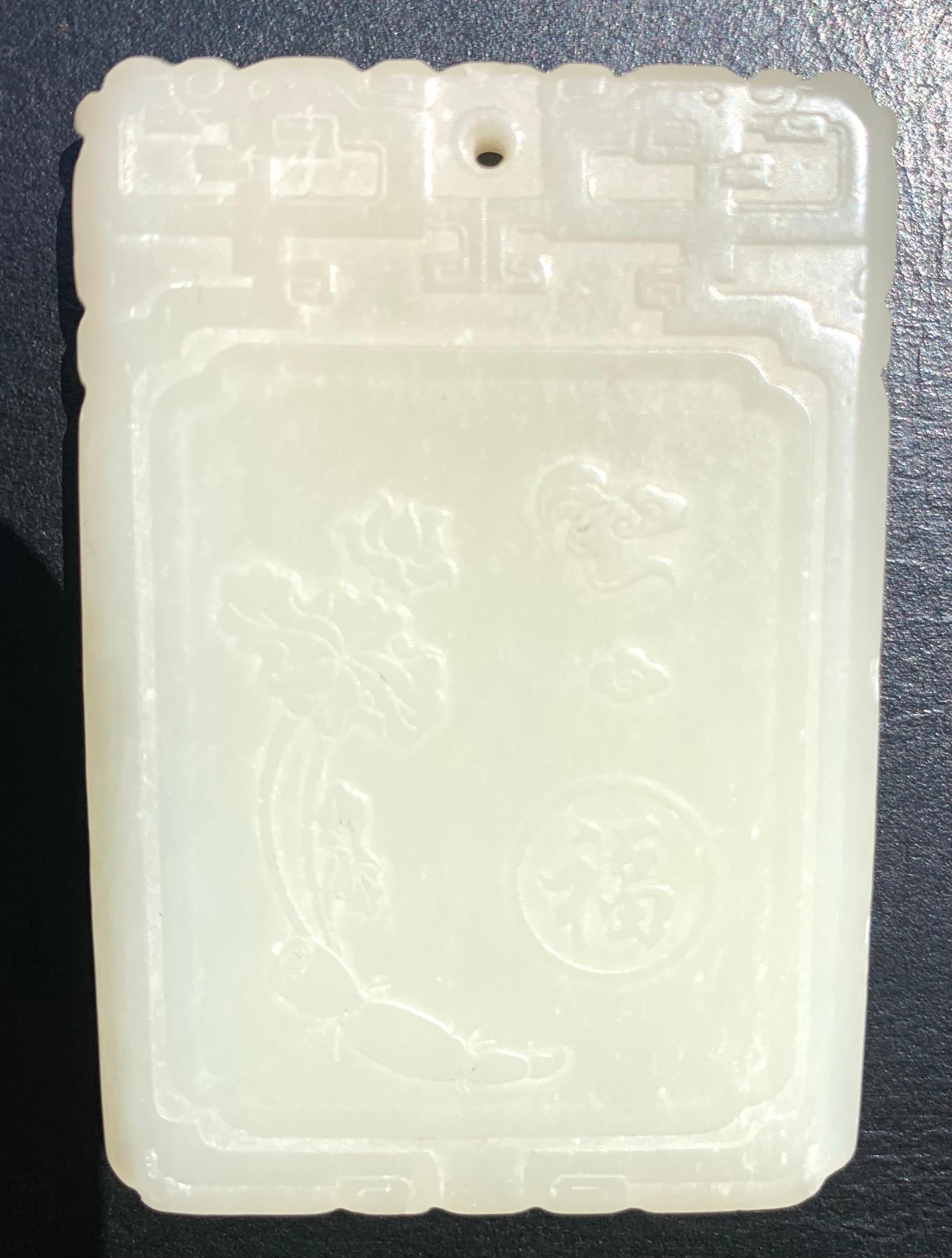 Fine antique 19th century Qing Dynasty celadon jade pendant plaque of rectangular form, exceptionally well carved on both sides. On one side, a beautiful Quan Yin is ridding a mythical beast, Qilin, who is prancing atop stylized clouds. She holds a