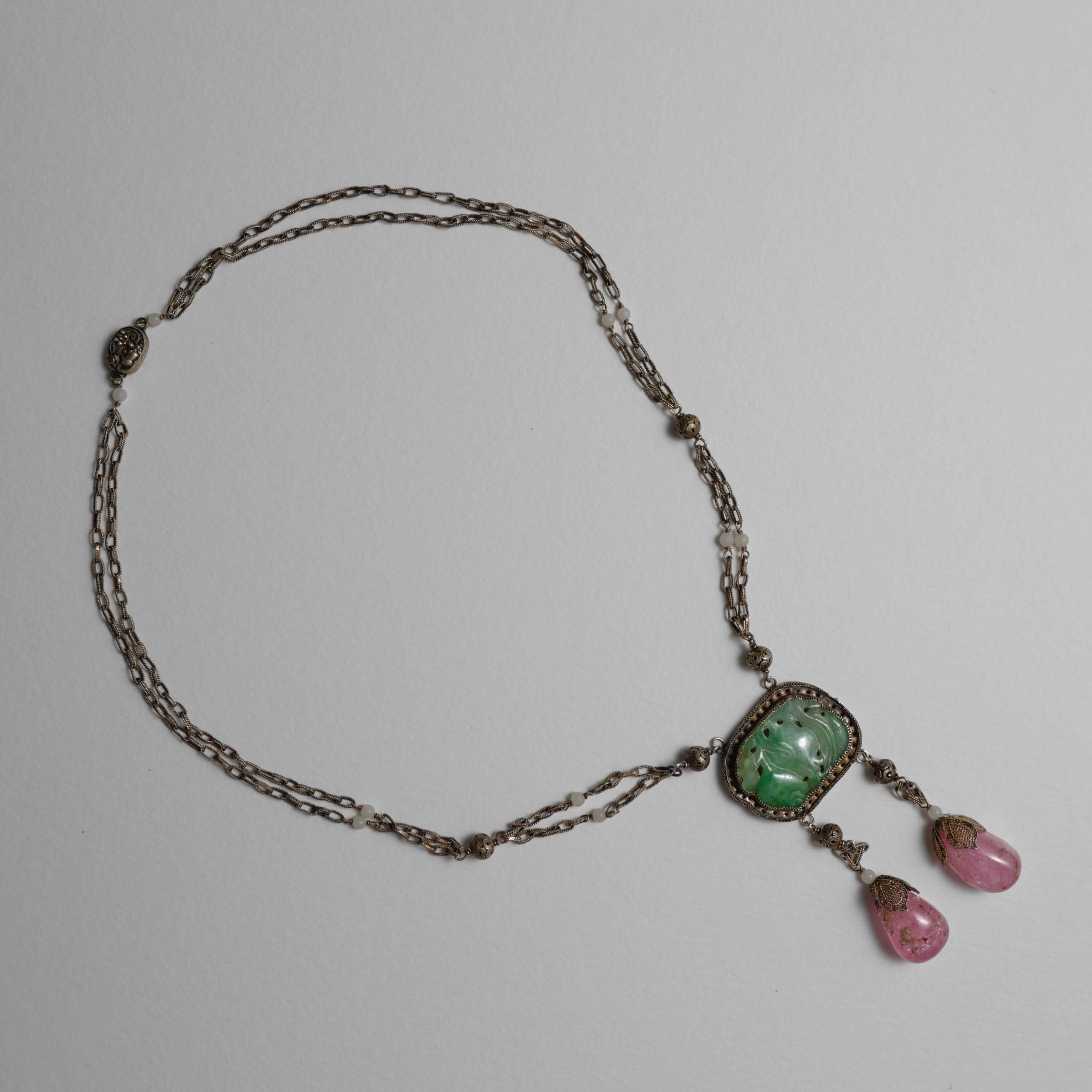 Created just after the turn of the century (circa 1917), this gilt silver jadeite and tourmaline drop necklace was created in China for the export market. Intricately detailed wirework that today would be nearly impossible to create by hand was