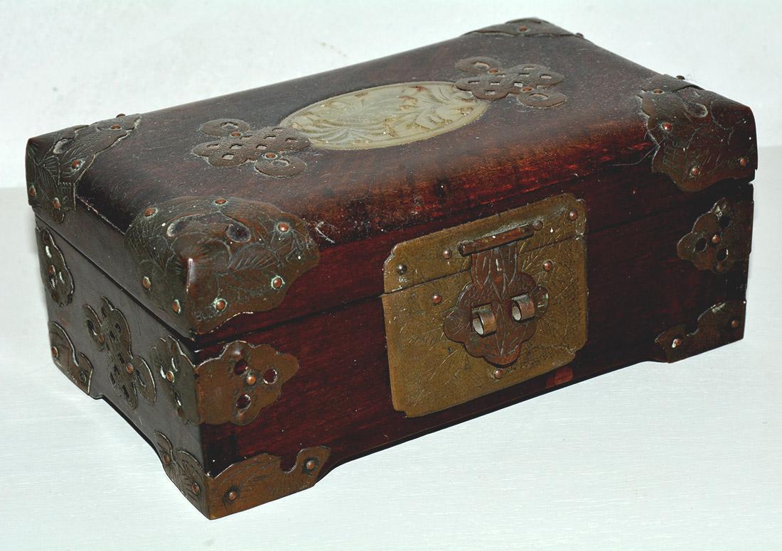 Chinese 19th century antique brass mounted wooden jewelry box with metal mounts and inset carved jade piece on the lid. Silk lined center compartment with two side sections for ring storage.