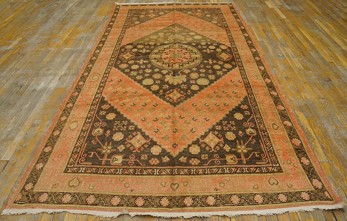 Early 20th Century Central Asian Khotan Carpet with a coral colored background along with a diamond shaped pattern. 
( 5'6