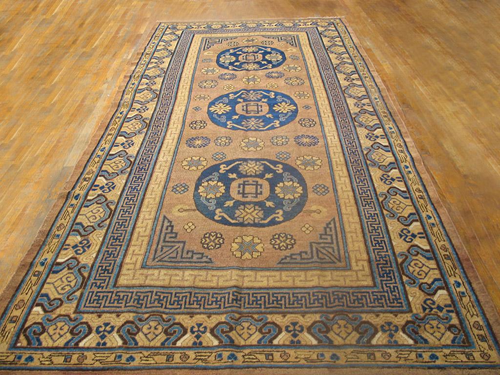 19th Century Central Asian Khotan Carpet with ocher background and patterned border.
( 6'3