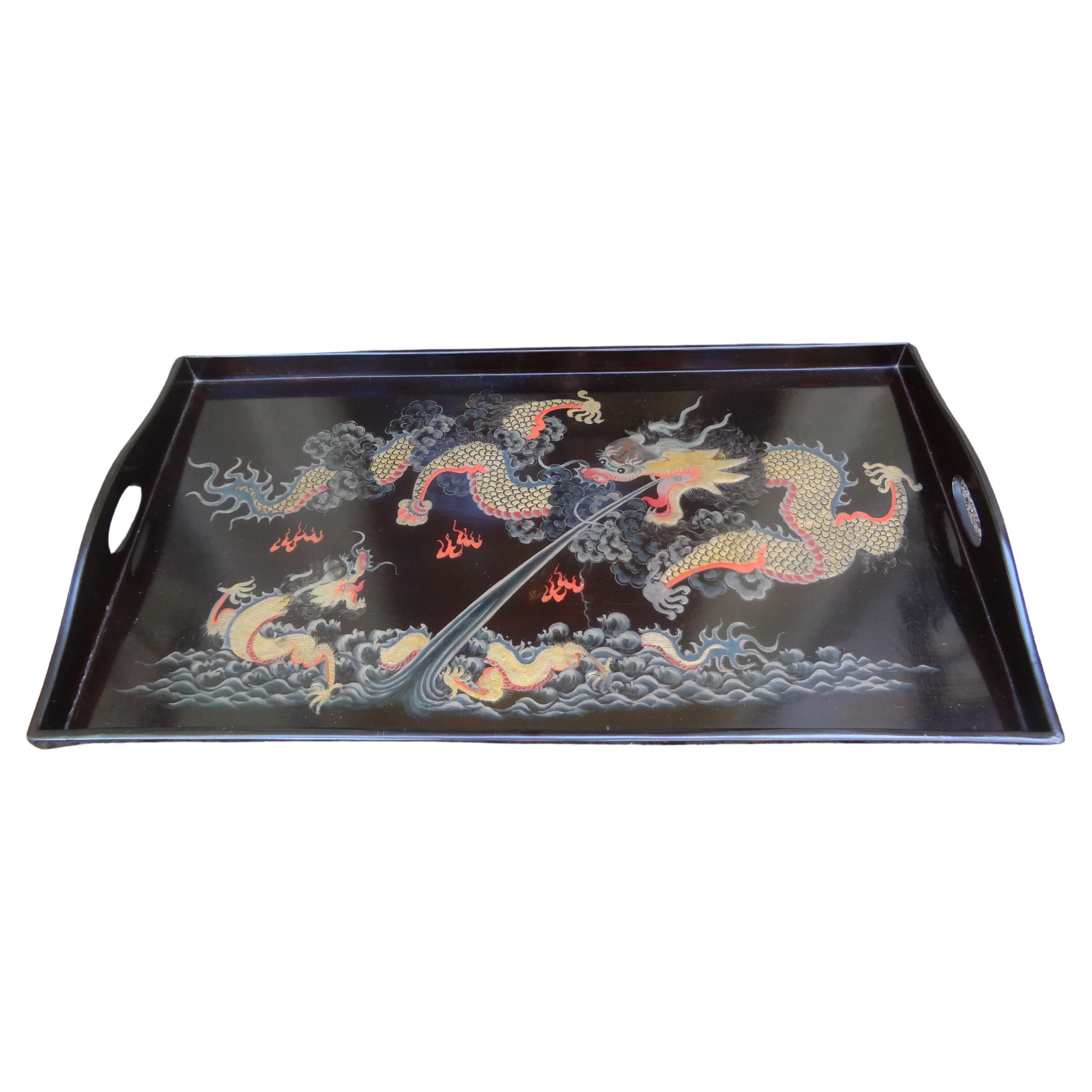 Antique Chinese Lacquer Tray With Dragons.
Our stunning Chinese lacquer tray is rectangular with two handles and hand decorated with gold and red dragons. Great decorative tray for a coffee table, bookcase or displayed on an easel.
