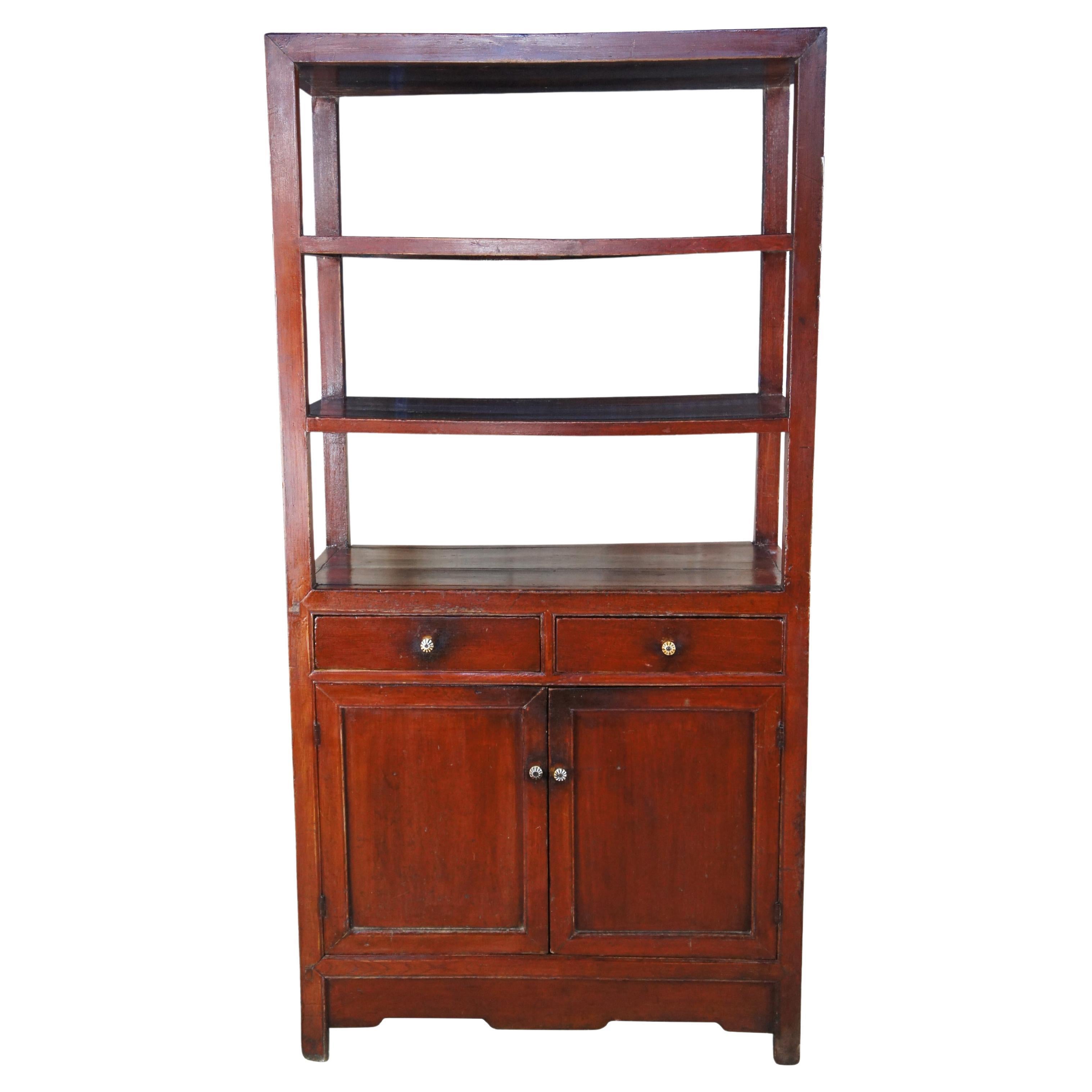 Early 20th century Chinese elm etagere cabinet. Features a modernist open form with three shelves over two dovetailed drawers and lower cupboard for storage. Constructed via mortise and tenon joinery. Great for use as a dry bar, room divider,