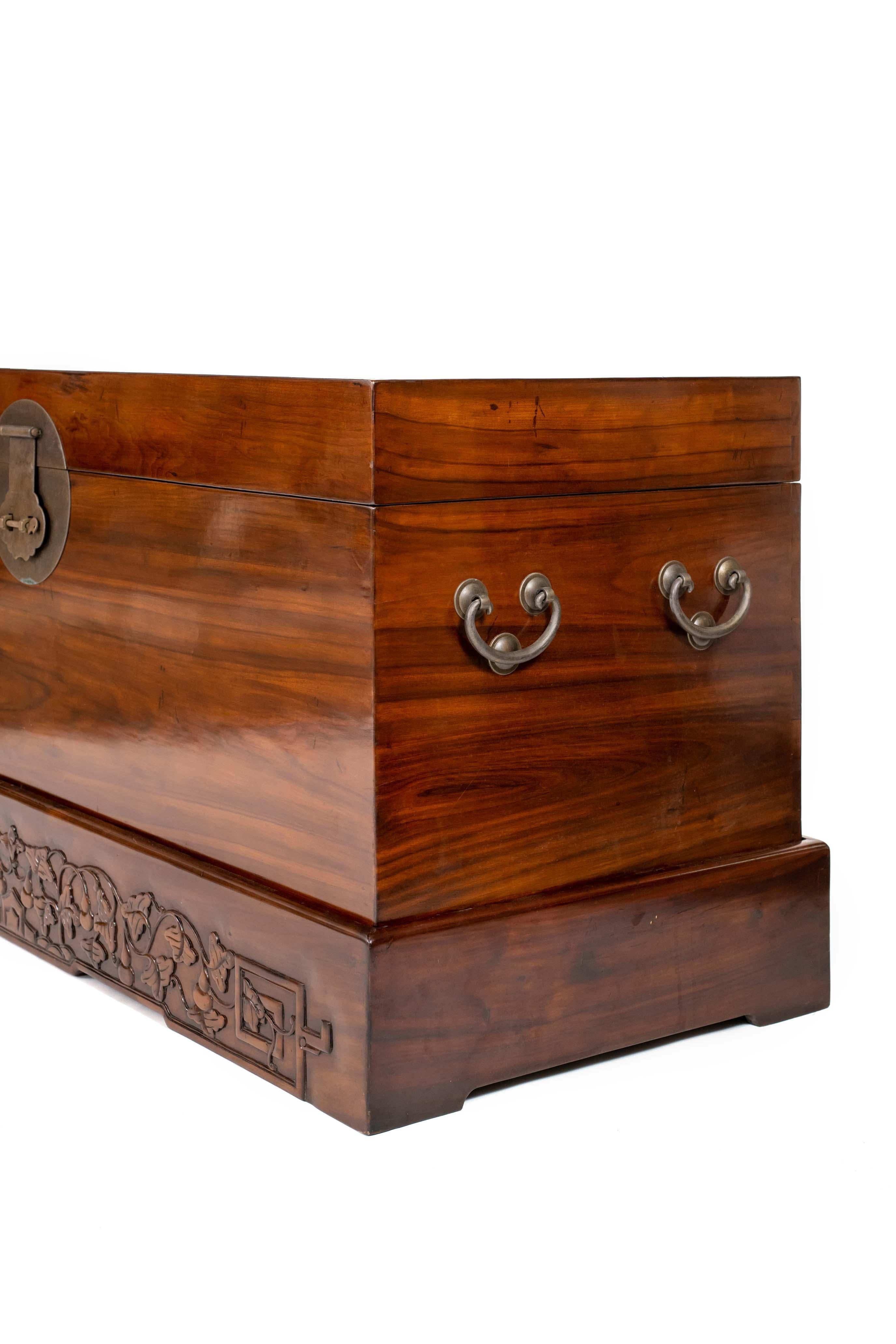 Hand-Carved Antique Chinese Large Camphor Fur Chest on a Base with Hidden Wooden Rollers For Sale