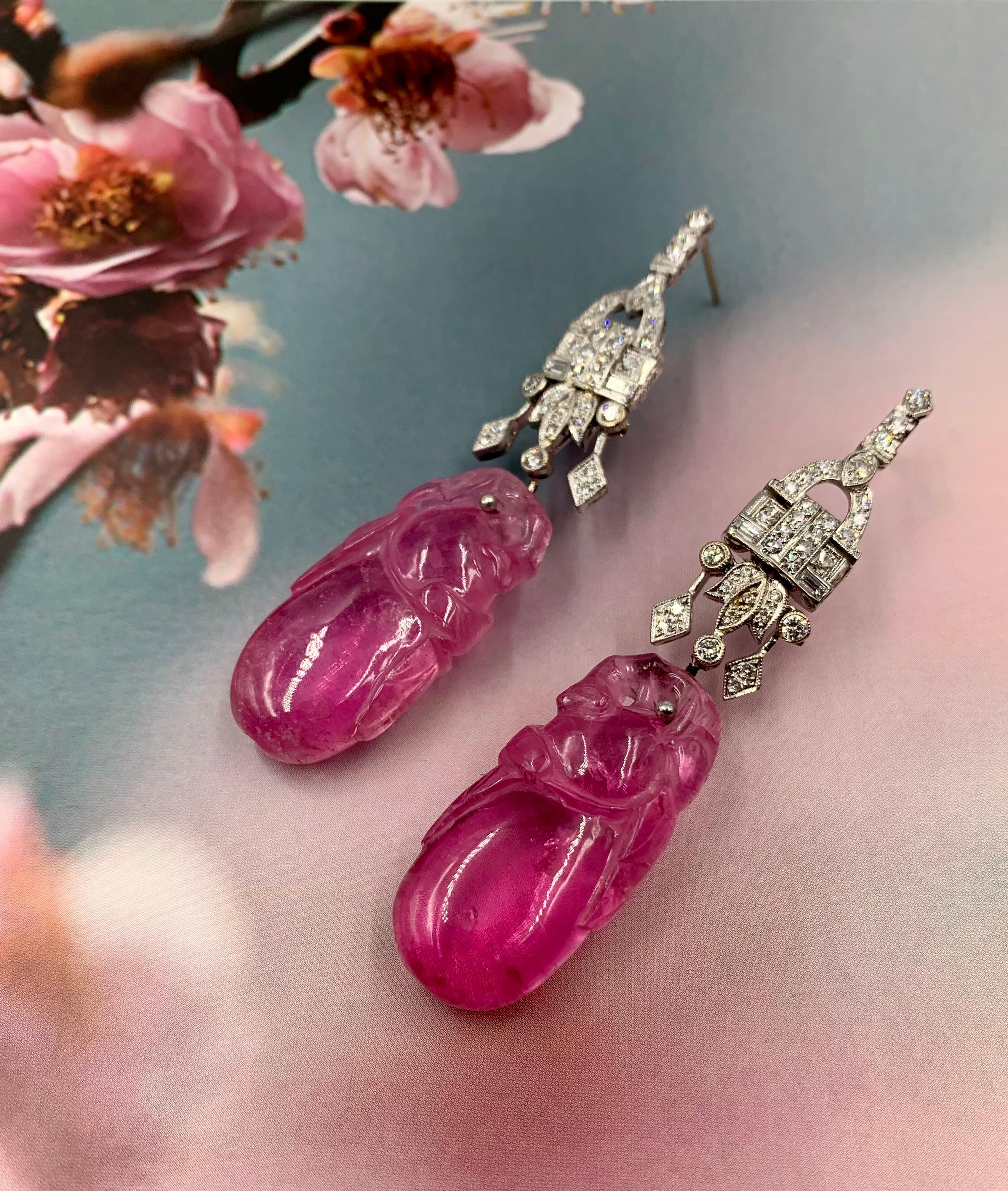 Late Qing
The antique Chinese tourmaline carvings depicting a pair of birds, perhaps magpies, on a gourd, a symbol of mystery, longevity and used as an amulet. The pair of magpies representing double happiness. 
Tourmalines: Each measuring 32mm by