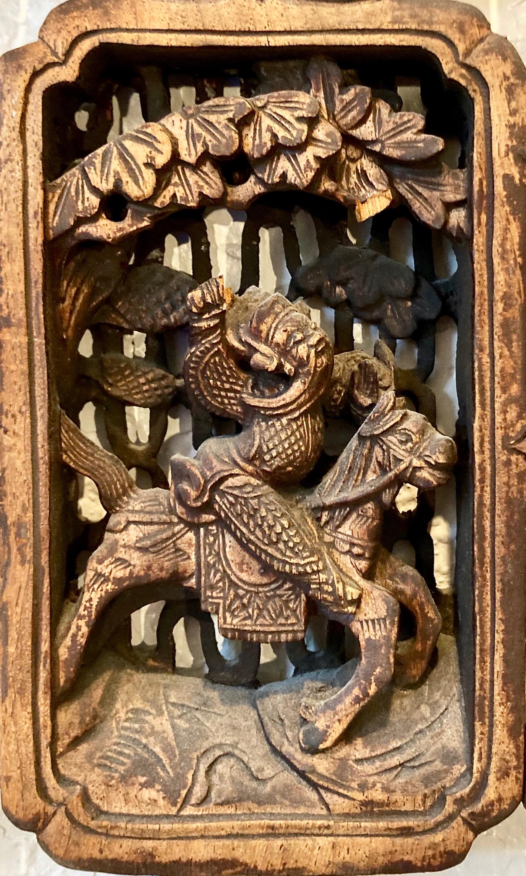Lattice work panel with mortise + tenon joinery, and small symbolic carvings inset throughout. Rectangular center carving with horse and rider motif.