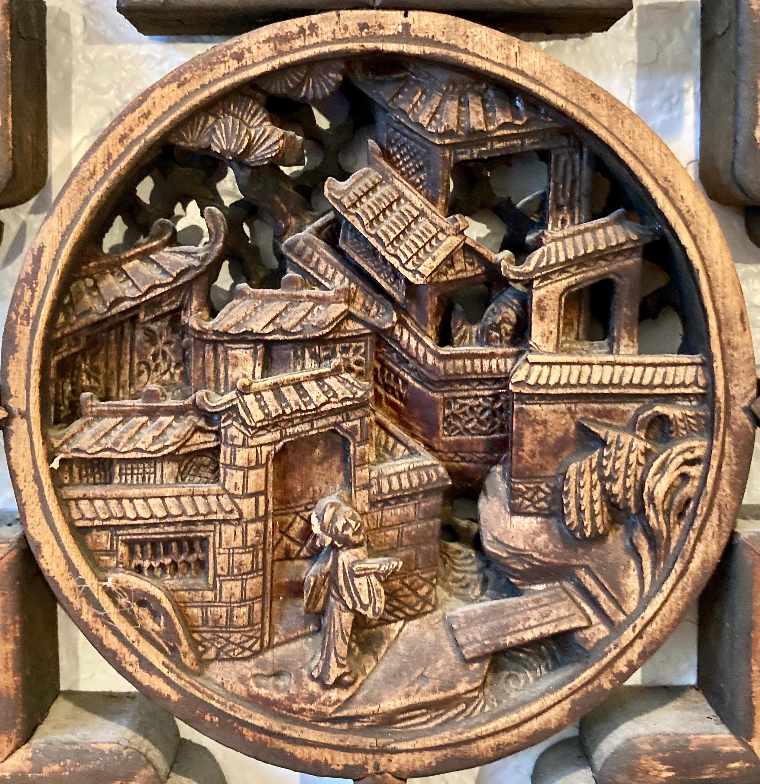 Lattice work panel with mortise + tenon joinery, and small symbolic carvings inset throughout. Circular center carving with personage and dwelling motif.