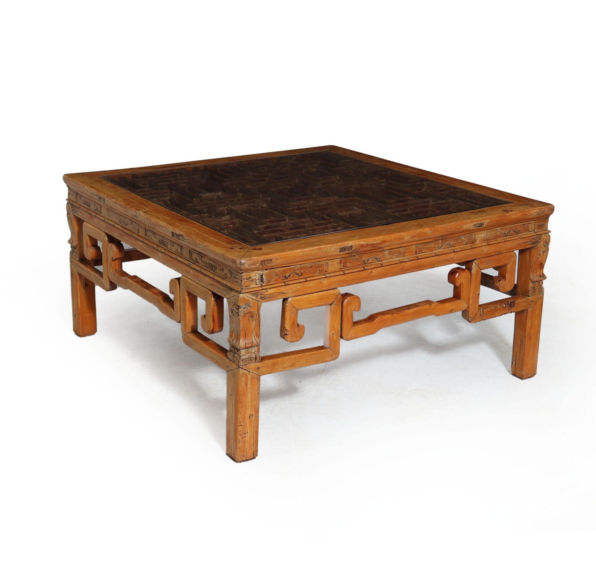 A Chinese table produced around the 1900s from hardwood with great light colour with light carved details, lattice work top and new glass top, the table is in original condition with minor losses and wear has benefitted from a wax finish
Age: