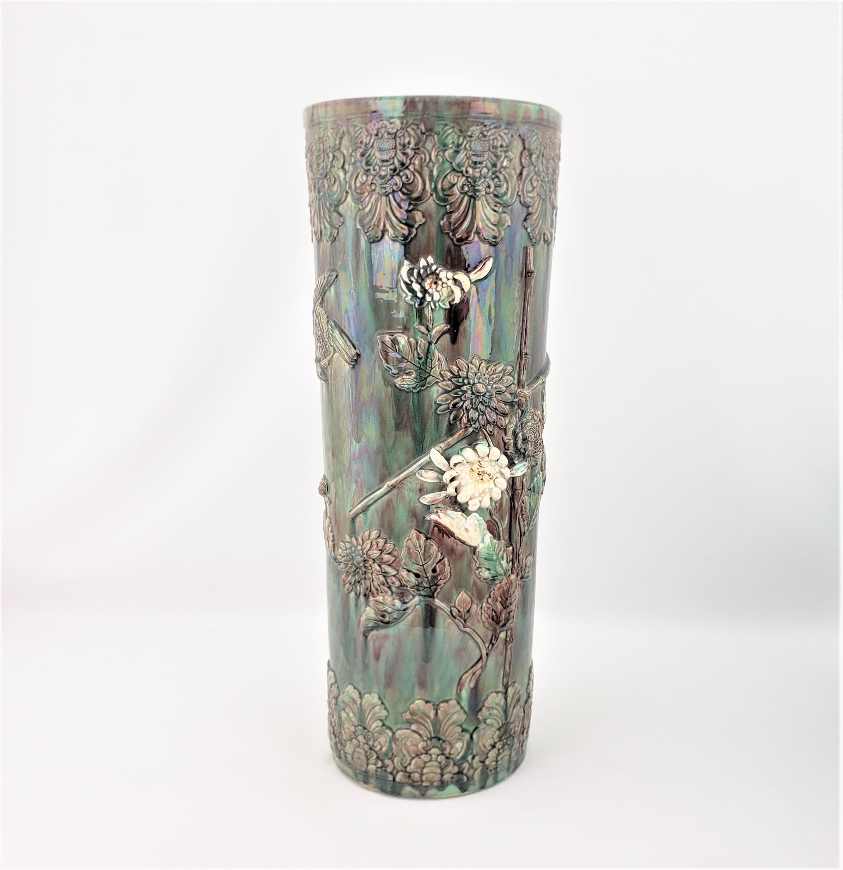 This antique umbrella stand is unsigned, but presumed to have originated from Asia, most likely China, and dating to approximately 1900 and done in a period Export style. This hand-crafted umbrella stand is done in a vibrant lead glaze using a mix