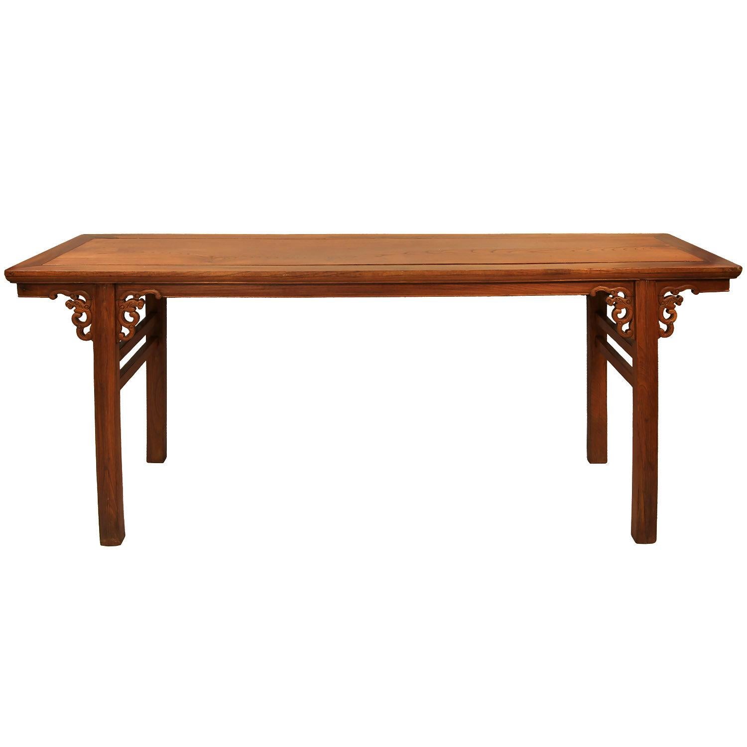 Early 20th Century Antique Chinese Library Table

Clean lines with hand carved, stylized dragon embellishments. At some point, the original lacquer finish was removed to show the wood grain. The wood grain finish was recently restored. Wear