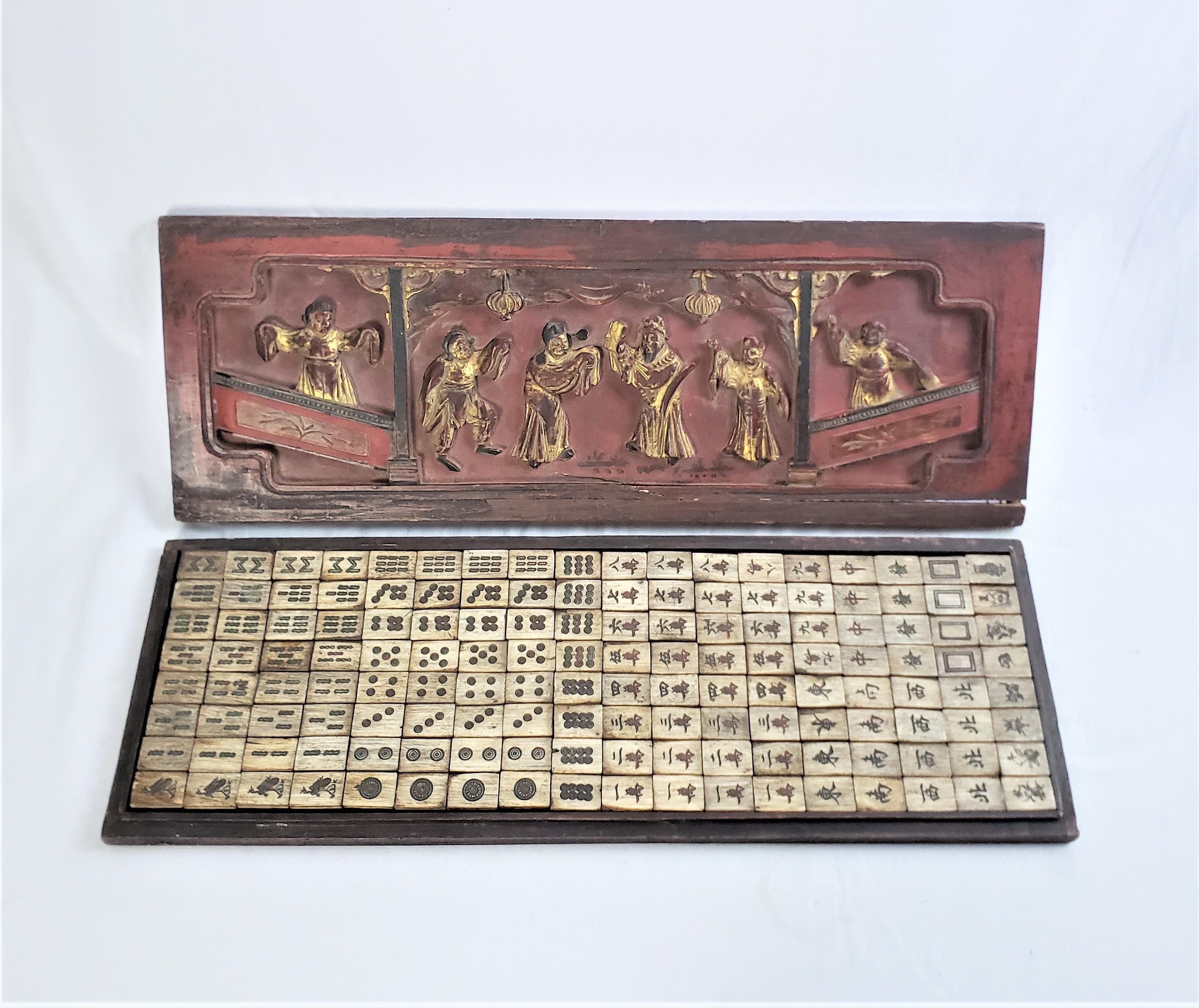 This antique Mahjong set is unsigned and documentation shows it to have originated from China and date to approximately 1900 and done in the Chinese Export style. The set is composed of 144 tiles composed of a ebonized softwood with a bakelite top