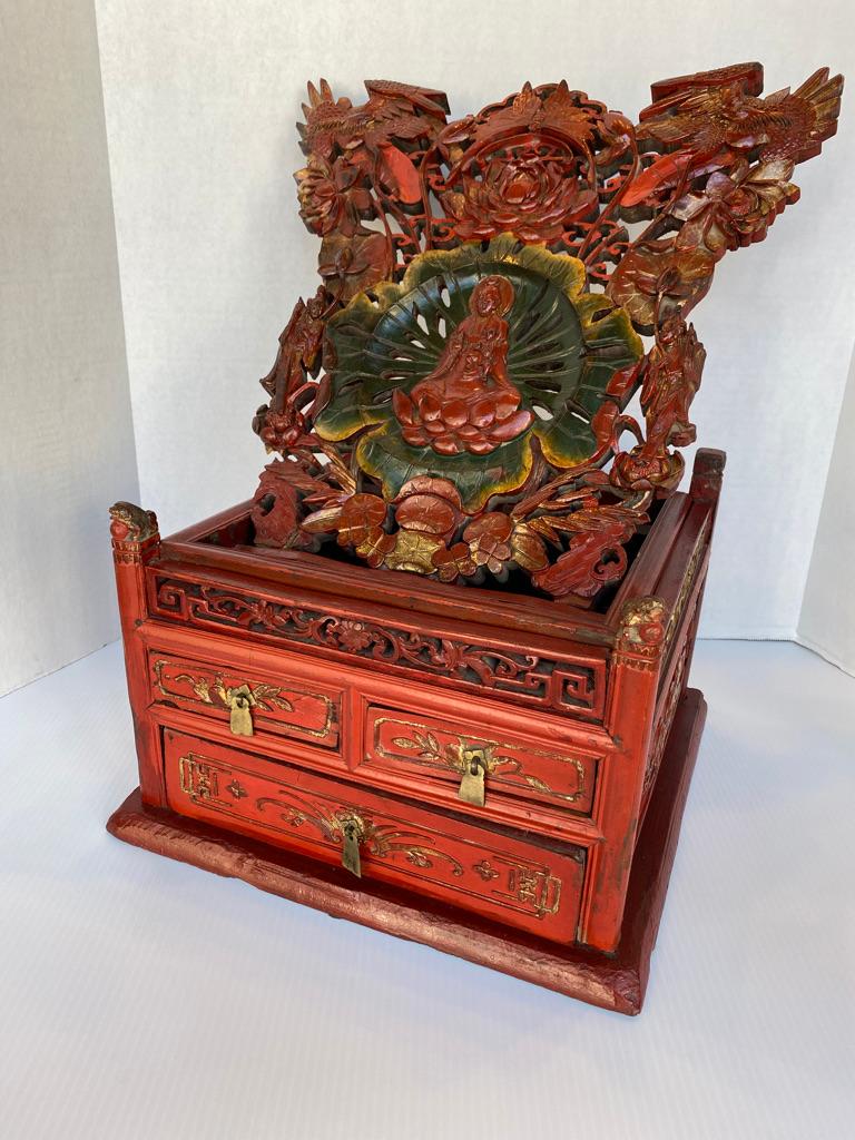 This is the best I have ever seen!!! Having one long 2 short drawers brass handle pulls. Hand carved with red and green lacquer finish. The carving is Qing Yin to the center carving flower birds and attendants. Having small foo dogs to each side.