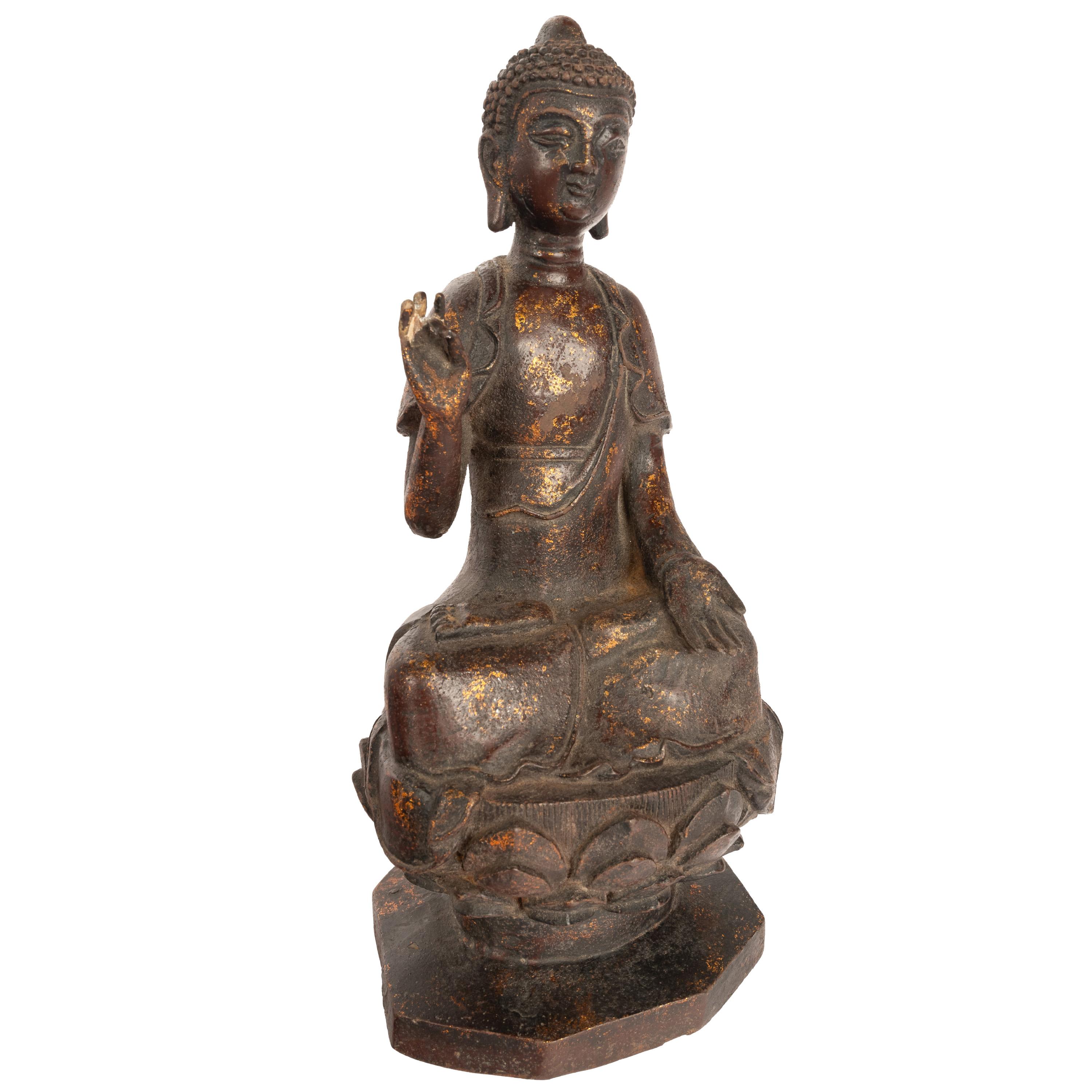 A good antique Chinese Ming dynasty gilt bronze statue of the Buddha, circa 1600.
The bronze depicts the Buddha in a protection pose, the statue is shown seated on a lotus flower throne, with remnants of gilded decoration & a four character mark to